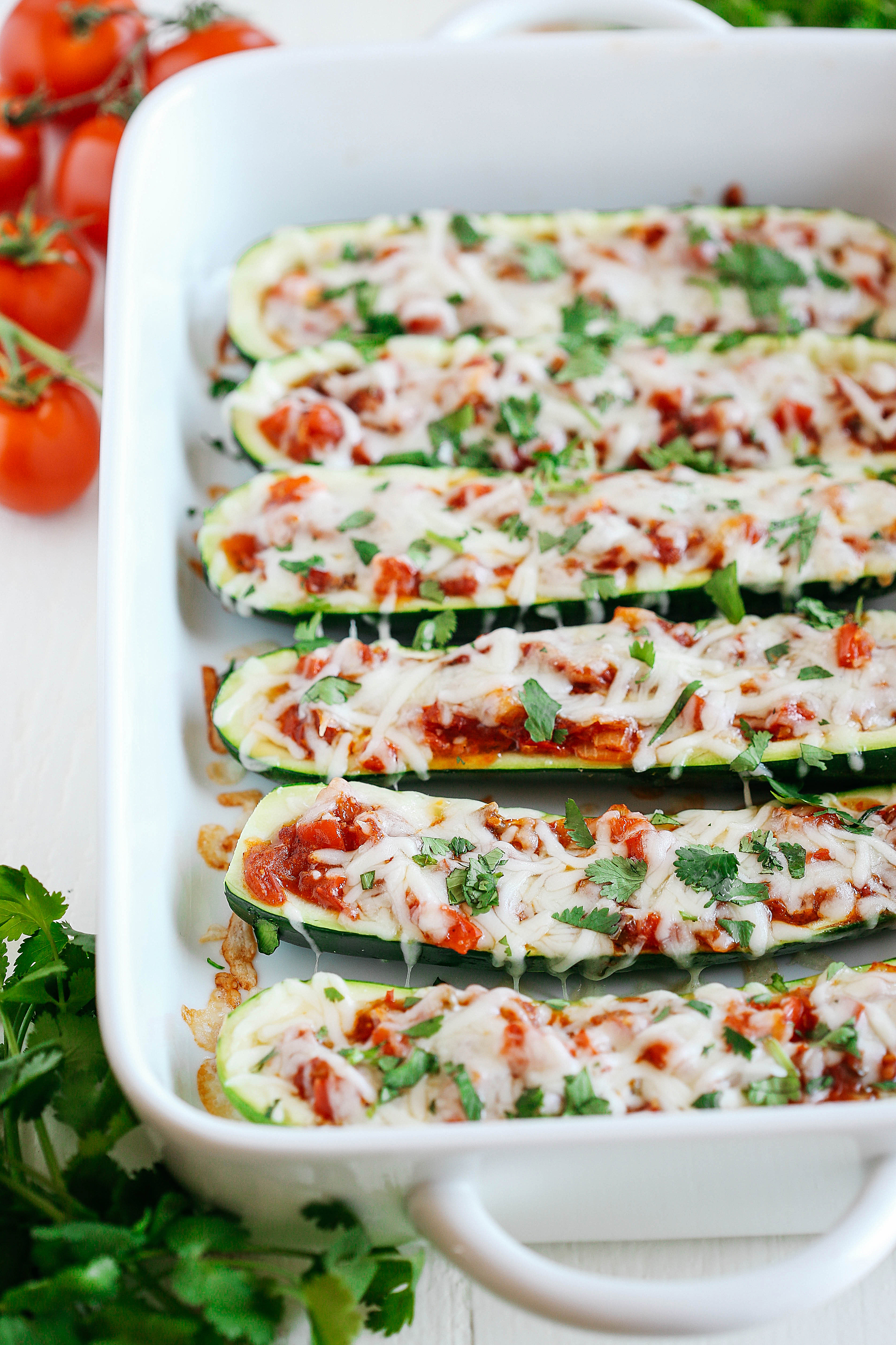 These Enchilada Stuffed Zucchini Boats are super flavorful, easy to make and are a much healthier alternative to your favorite dish!