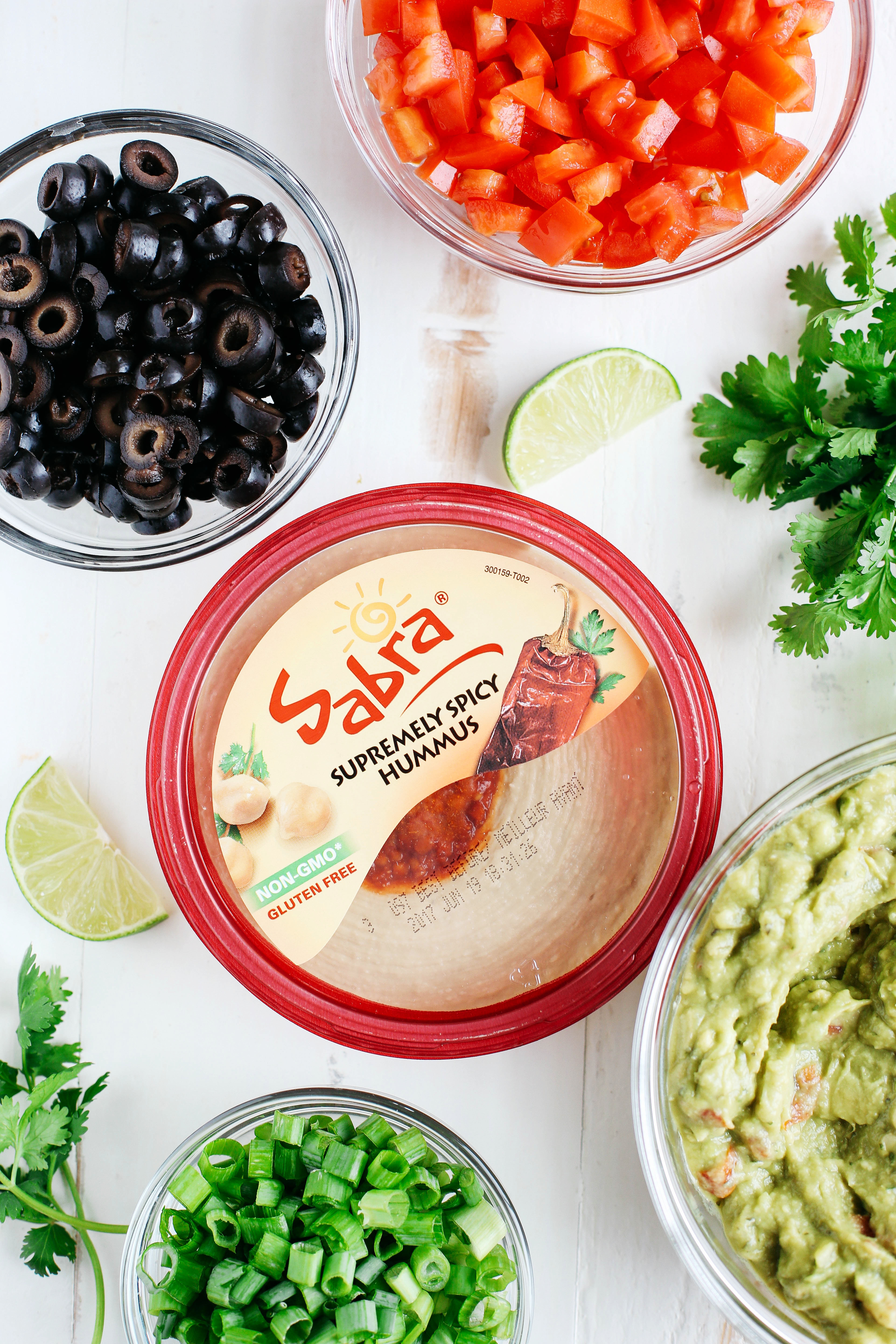 This Healthier 7 Layer Spicy Taco Dip is a lighter take on your favorite party appetizer perfect for any gathering or event that you can enjoy guilt-free!