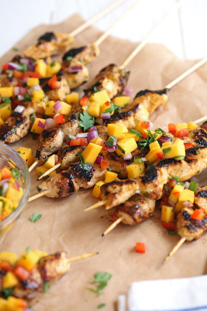 These Mango Sriracha Chicken Skewers are the perfect balance of sweet and spicy topped with a mango salsa that is sure to be a hit at your next cookout!