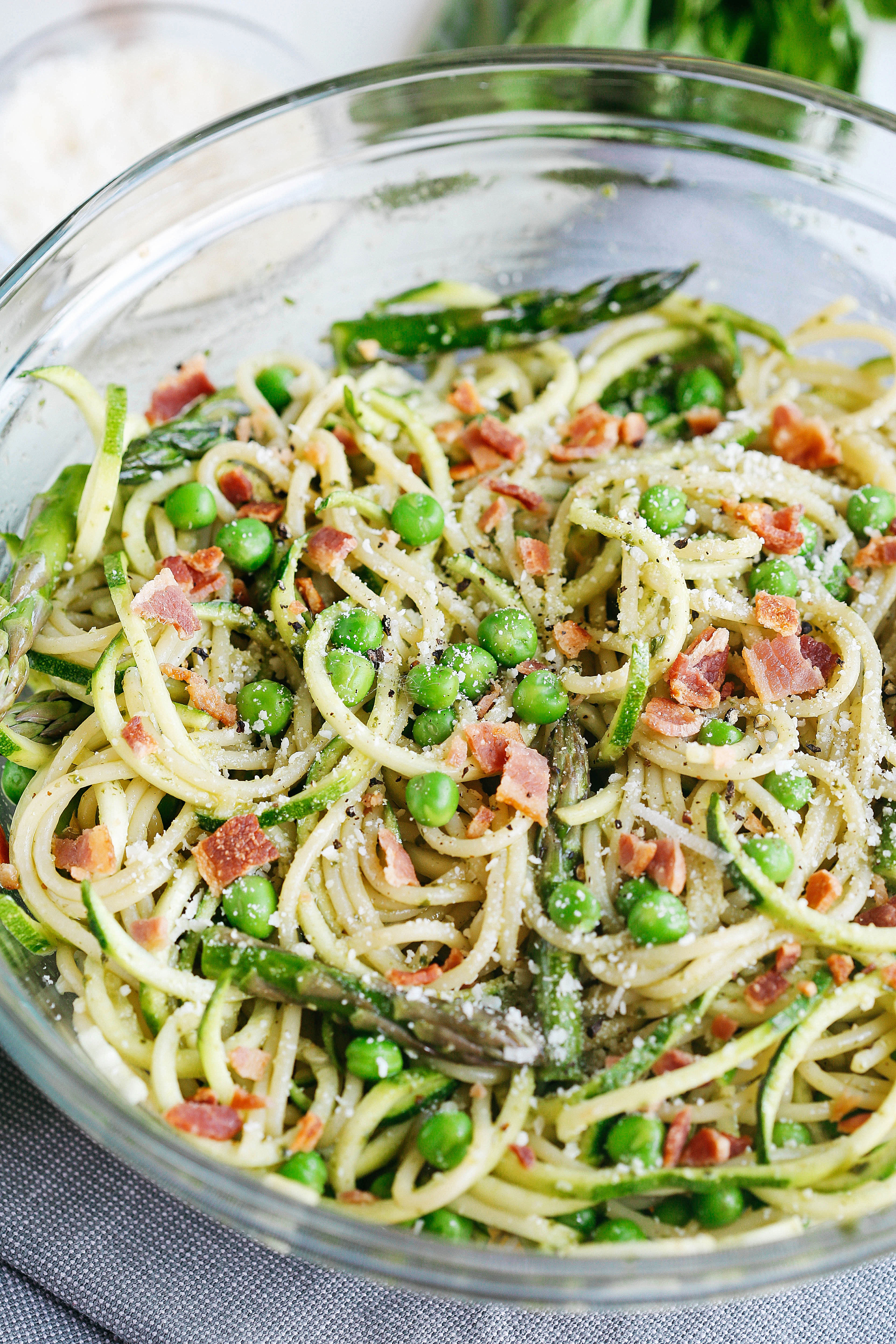 This delicious pasta salad is a lighter take on your favorite summer side dish that is loaded with fresh veggies and crunchy bacon all tossed together with a sweet basil vinaigrette for a meal that is both healthy and comfort food all in one!