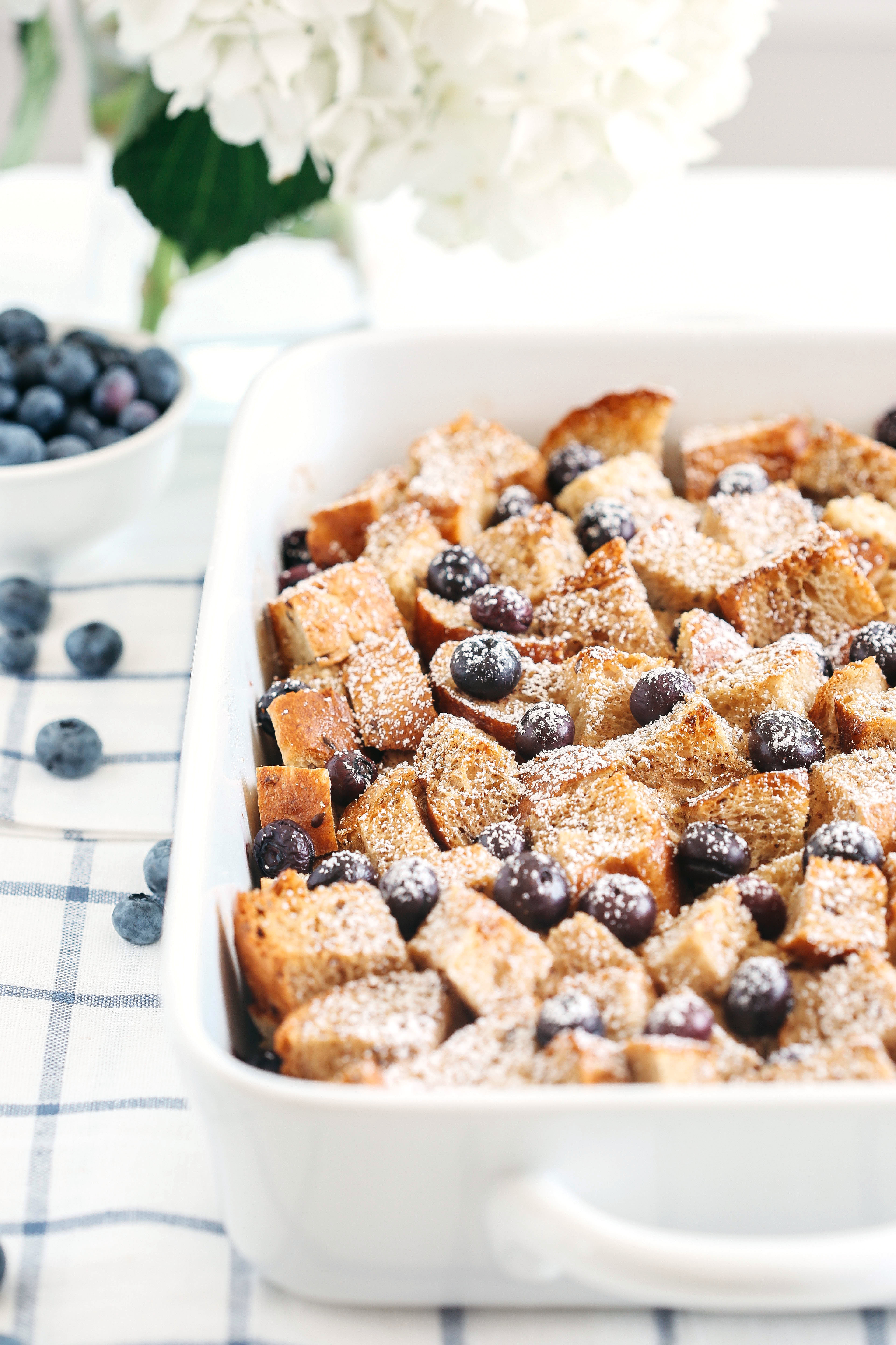 Warm and delicious Overnight Blueberry French Toast Casserole that is lighter in calories, high in protein and can easily be made the night before for the perfect morning breakfast!
