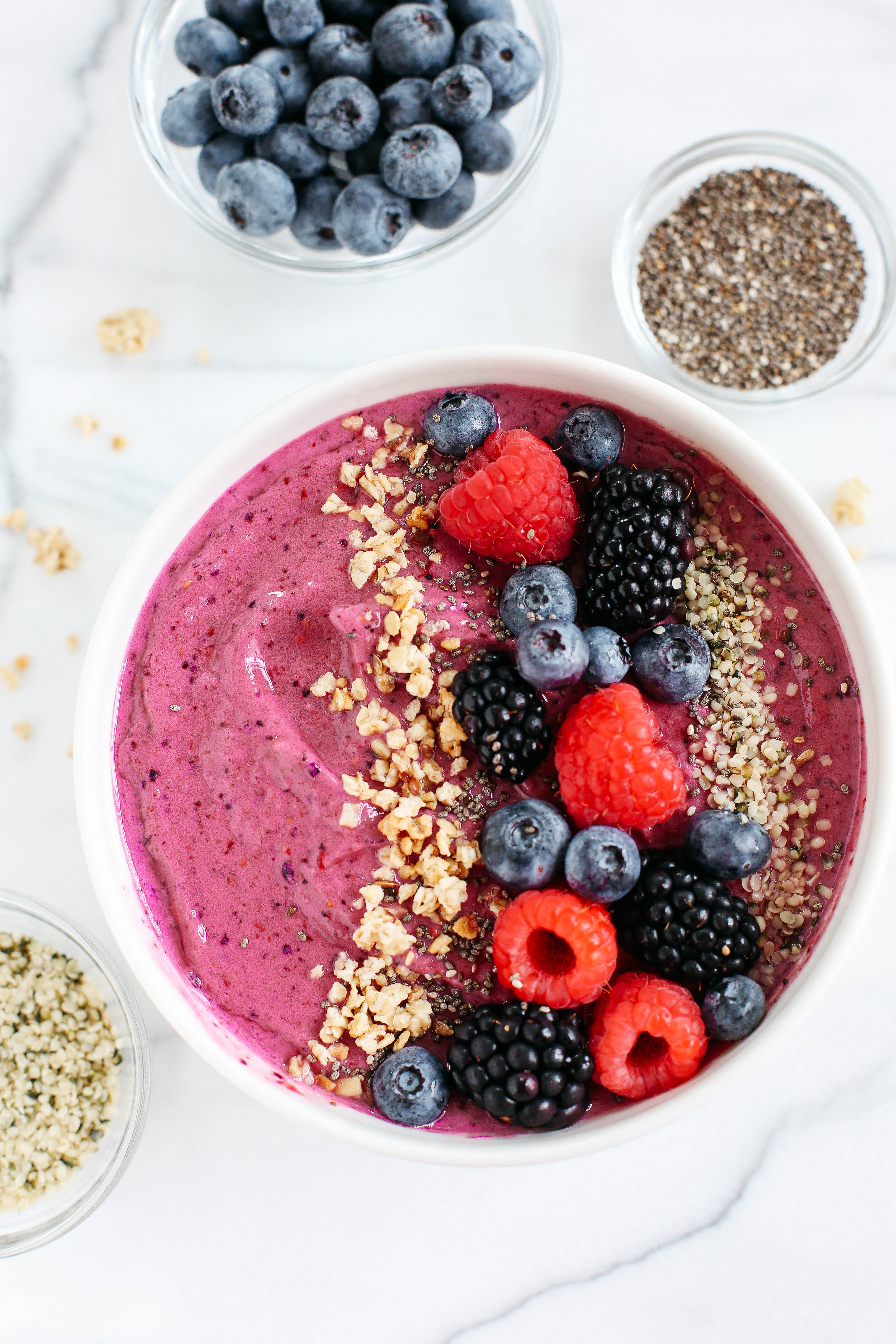 This Triple Berry Smoothie Bowl is creamy, delicious and super EASY to make with a variety of fun toppings and fresh fruit!