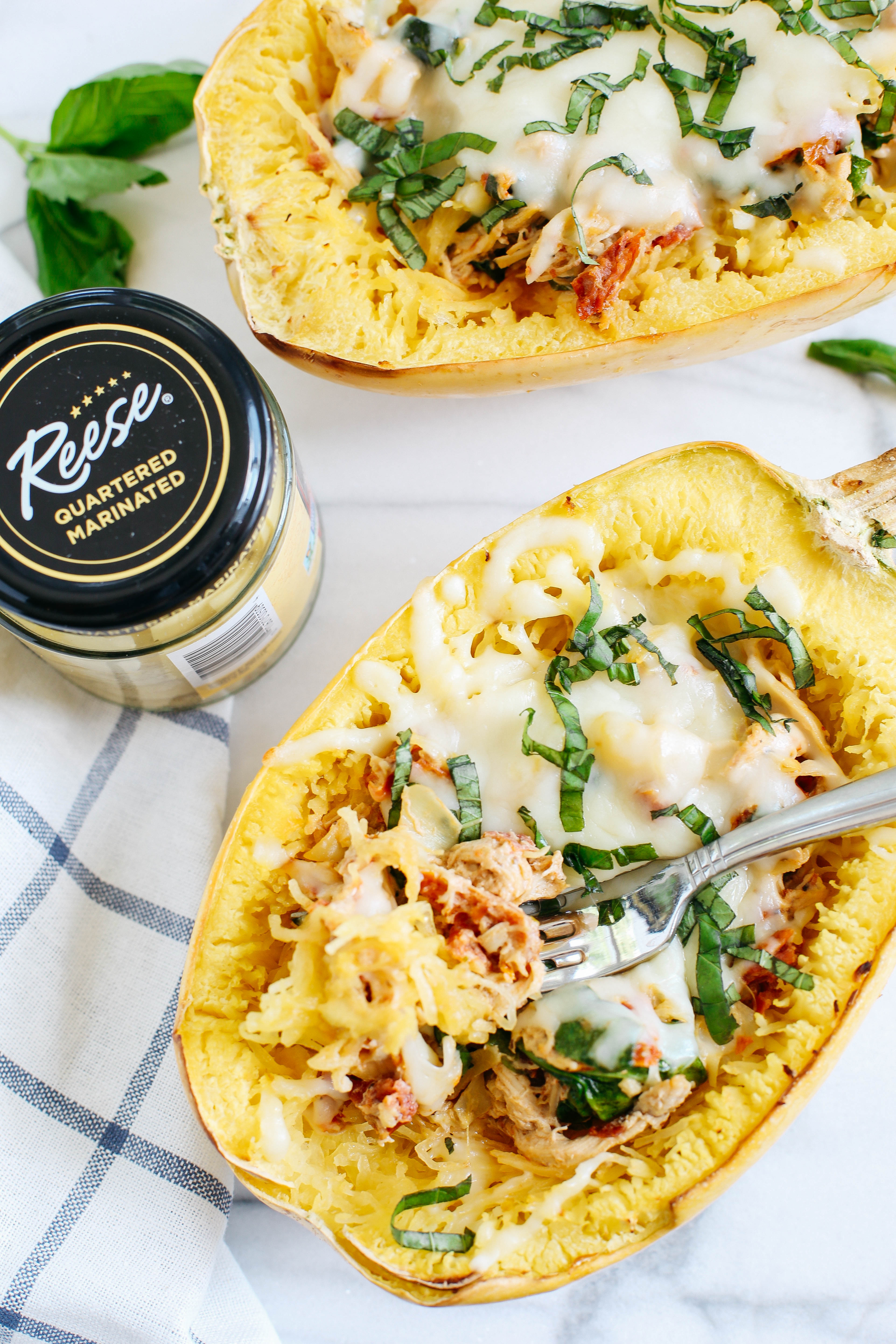 These Sun Dried Tomato and Artichoke Spaghetti Squash Boats are cheesy, delicious and make the perfect weeknight comfort meal that you can enjoy guilt-free! 