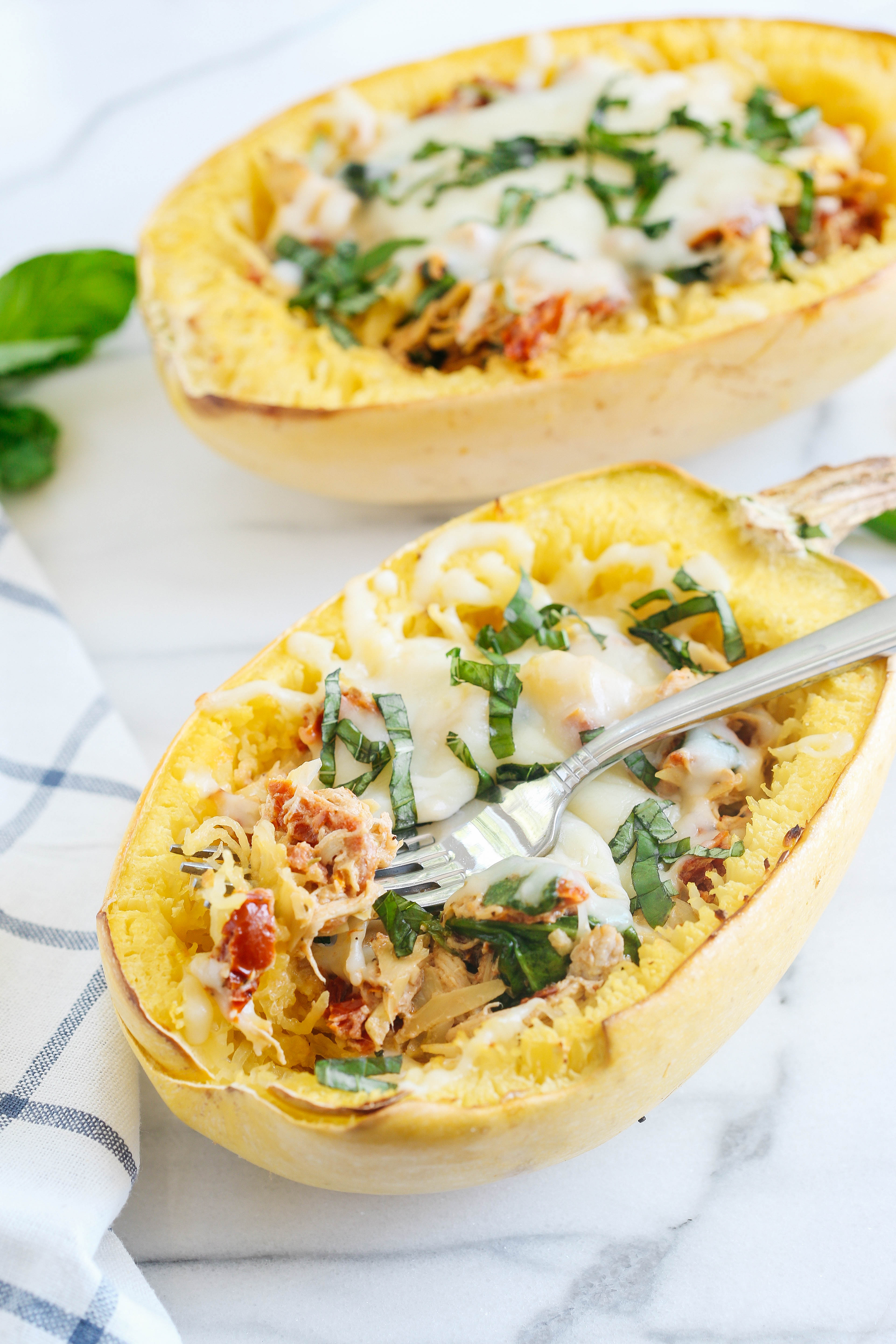 These Sun Dried Tomato and Artichoke Spaghetti Squash Boats are cheesy, delicious and make the perfect weeknight comfort meal that you can enjoy guilt-free! 