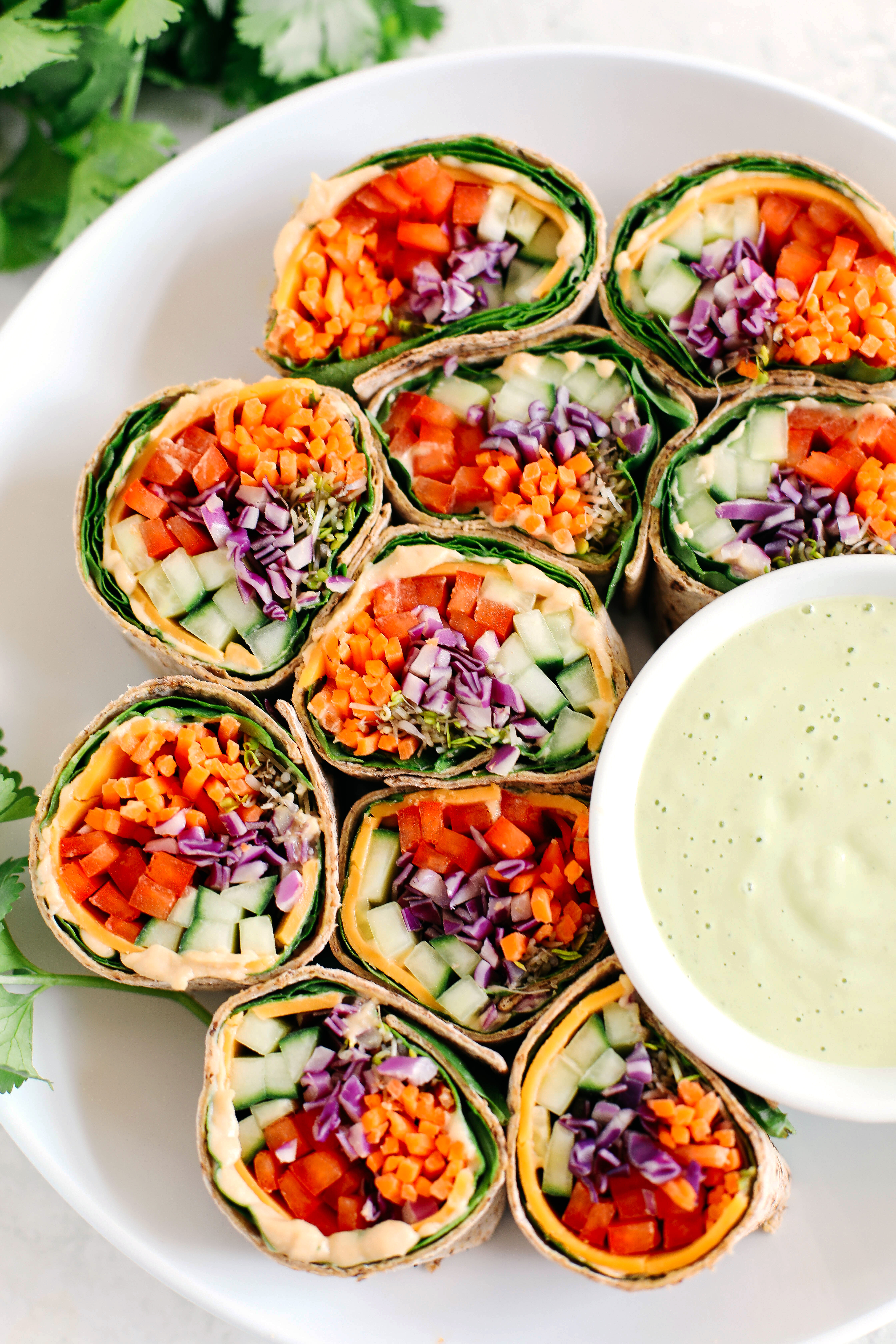 These colorful Rainbow Veggie Rolls are healthy, crunchy and loaded with tons of fresh veggies along with a delicious Ginger Avocado Dressing for dipping or drizzling!