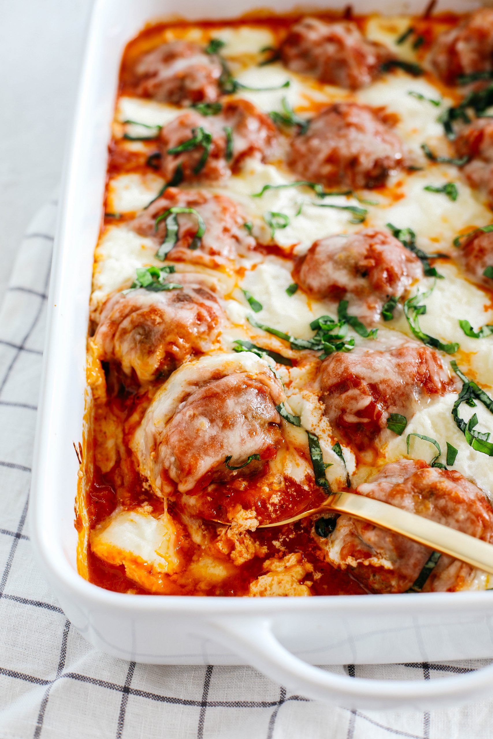 This Cheesy Keto Meatball Casserole is delicious and super filling with homemade meatballs topped with creamy ricotta cheese, mozzarella and parmesan for the perfect low carb meal your whole family will enjoy!