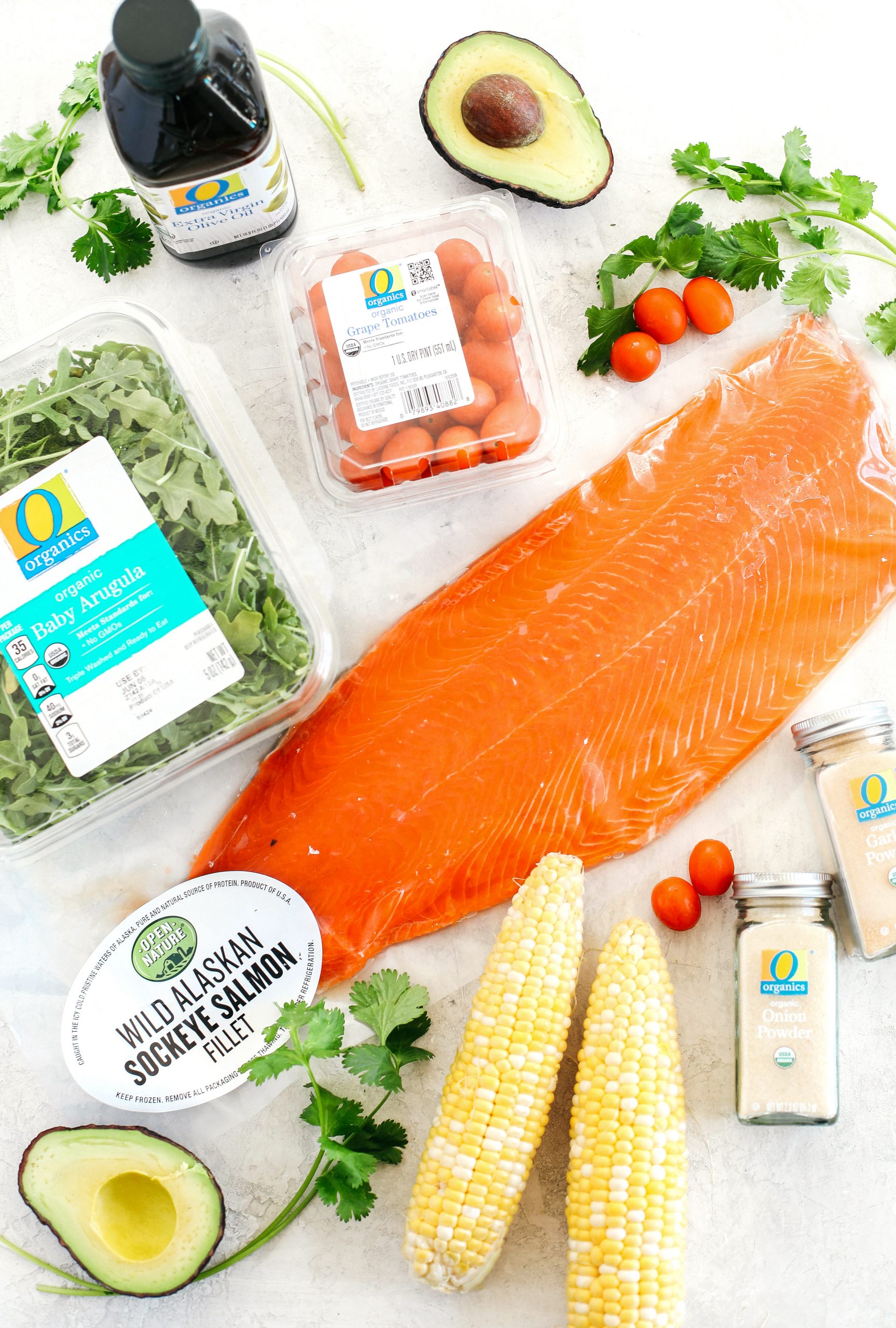 Chili-rubbed salmon with grilled corn, fresh tomatoes and sliced avocado all tossed together with a cilantro-lime dressing makes the perfect summer salad!