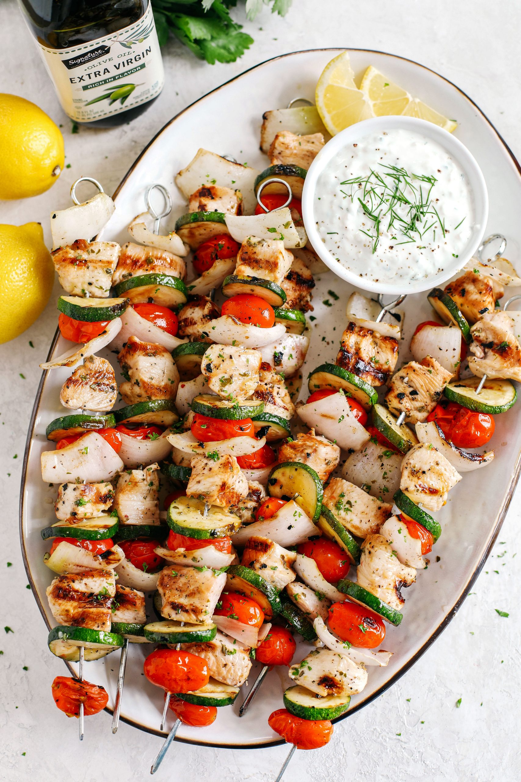 Super flavorful Greek Chicken Kabobs marinated with zesty lemon juice, garlic and fresh herbs and served with the most delicious homemade tzatziki dipping sauce!