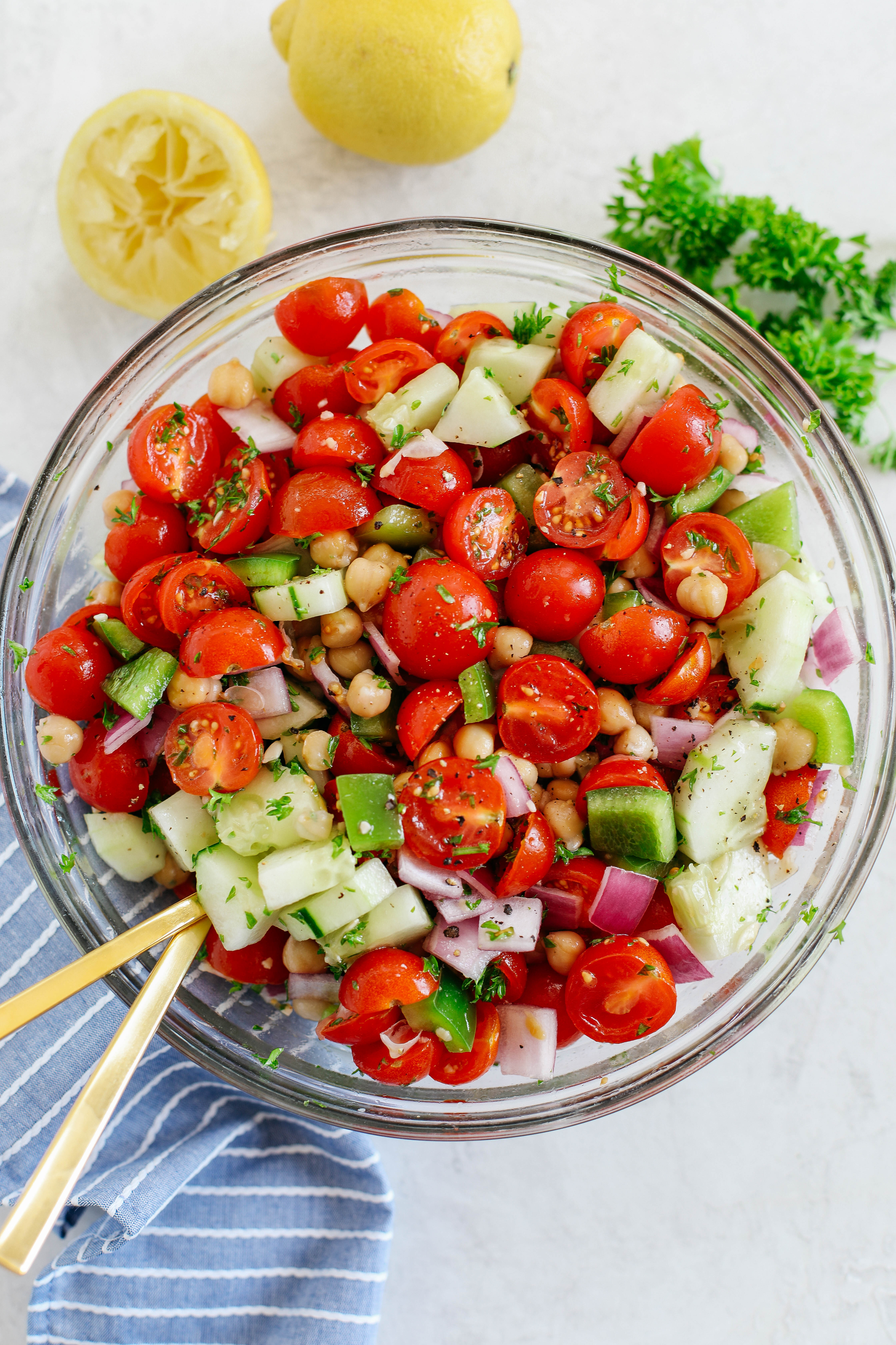 This Tomato, Cucumber and Chickpea Salad is a delicious summer staple that is quick, healthy and the perfect side dish with grilled chicken, fish or steak!