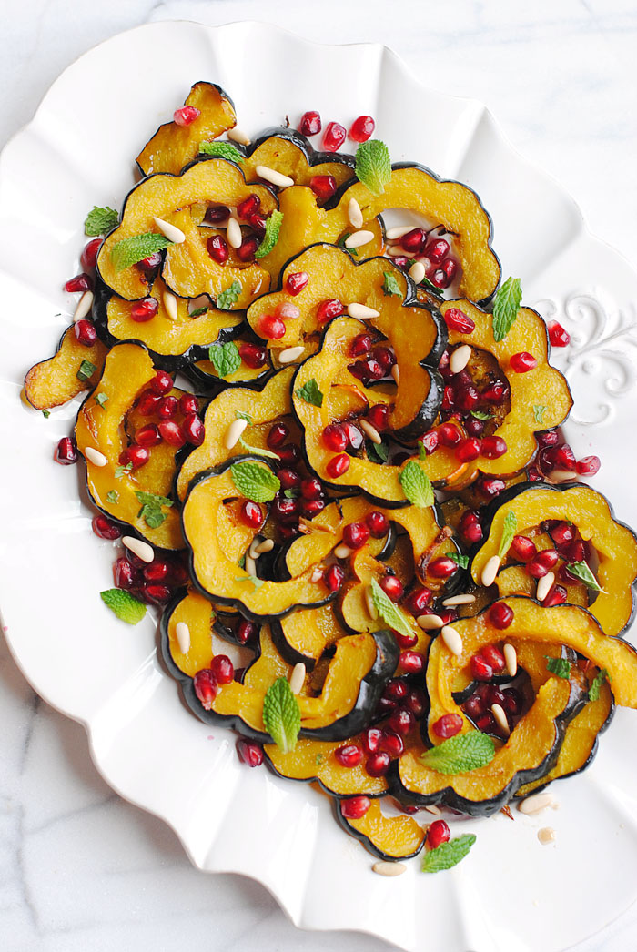 This Holiday Glazed Acorn Squash with Pomegranates and Pine Nuts is the perfect healthy side dish for your table this season!