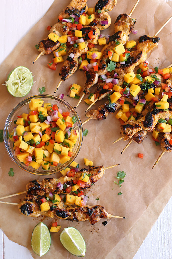 These Mango Sriracha Chicken Skewers are the perfect balance of sweet and spicy topped with a mango salsa that is sure to be a hit at your next cookout! www.eat-yourself-skinny.com