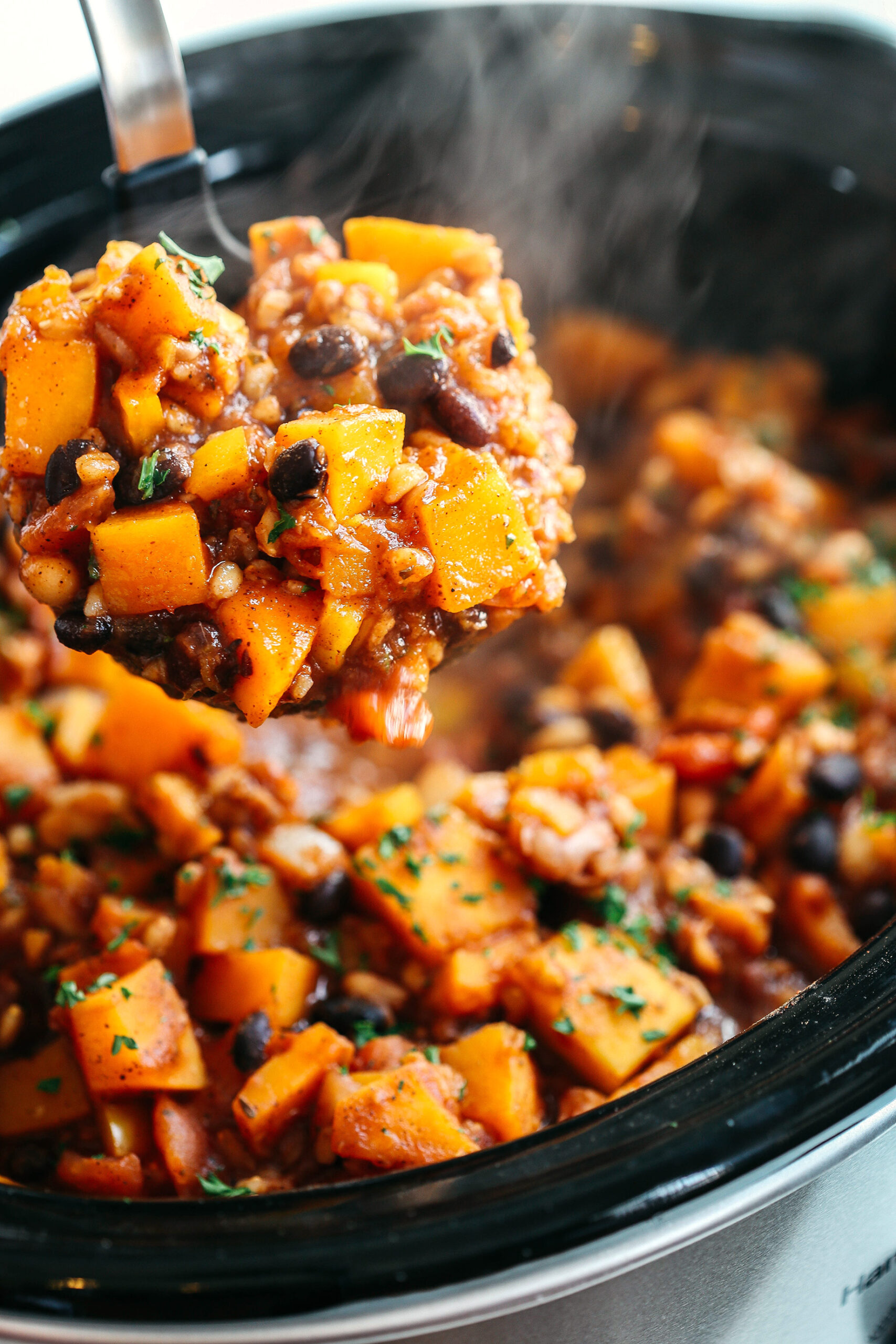 This Slow Cooker Butternut Squash and Farro Chili is hearty, healthy and loaded with seasonal veggies, tender farro, protein-packed beans, and cozy spices all simmered together in a delicious broth for the perfect fall meal!
