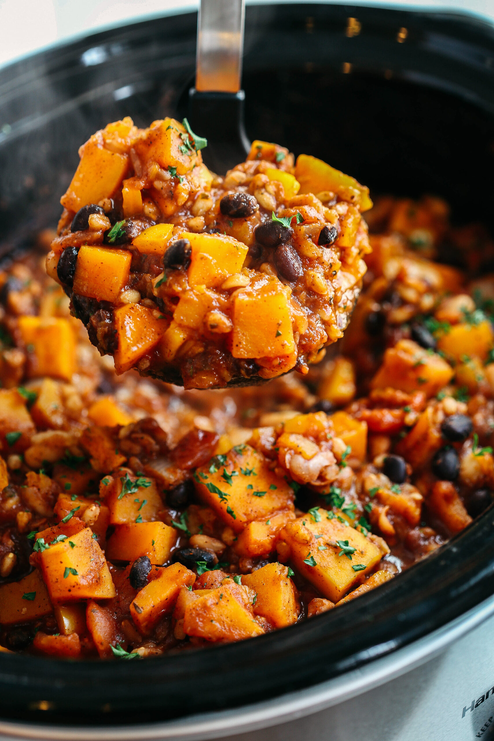 This slow-cooking pumpkin and Farro chili is filling, healthy, and loaded with seasonal vegetables, tender farro, protein-packed beans, and cozy spices, all simmered in a delicious broth for the perfect fall meal!