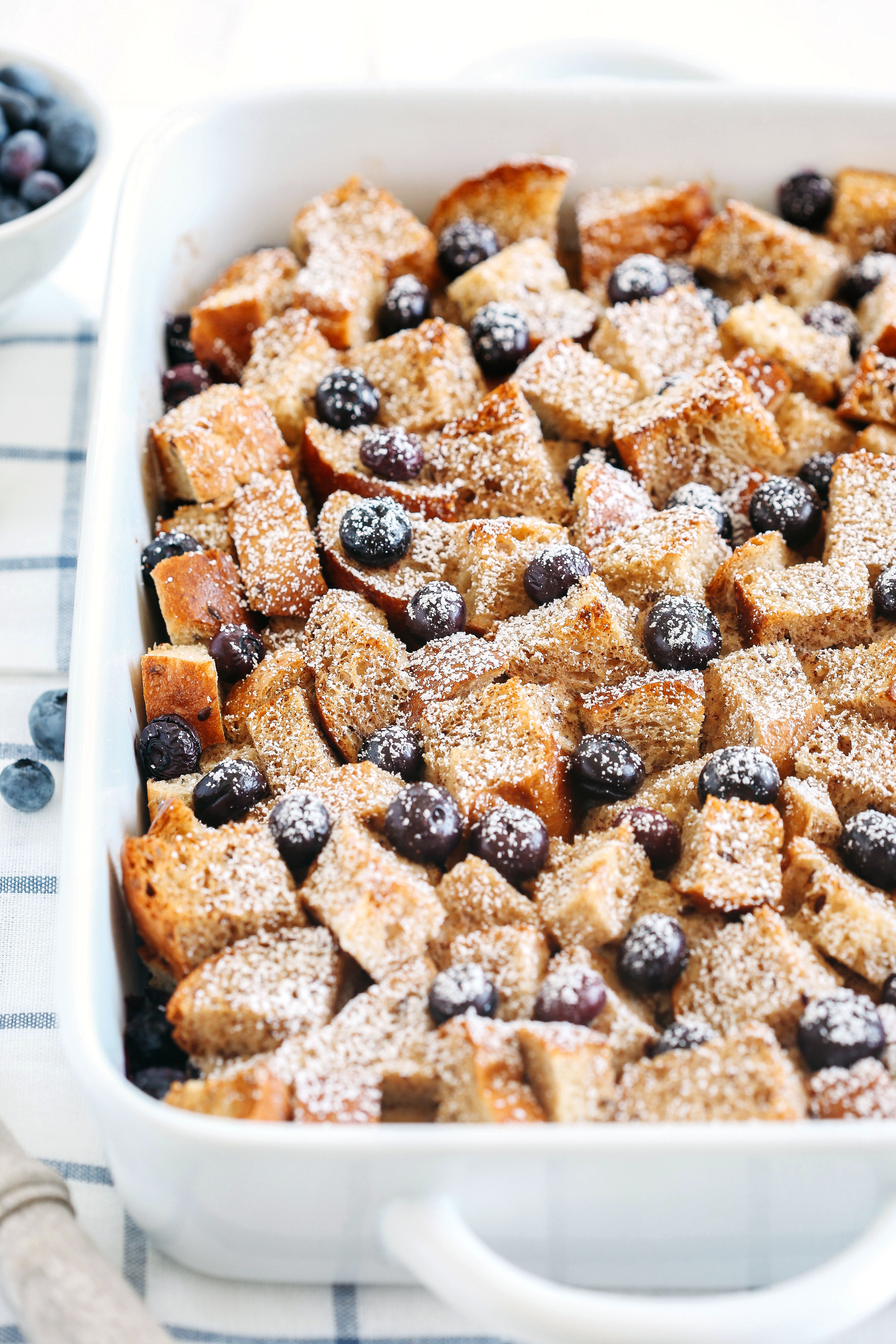 Warm and delicious Overnight Blueberry French Toast Casserole that is lighter in calories, high in protein and can easily be made the night before for the perfect morning breakfast!