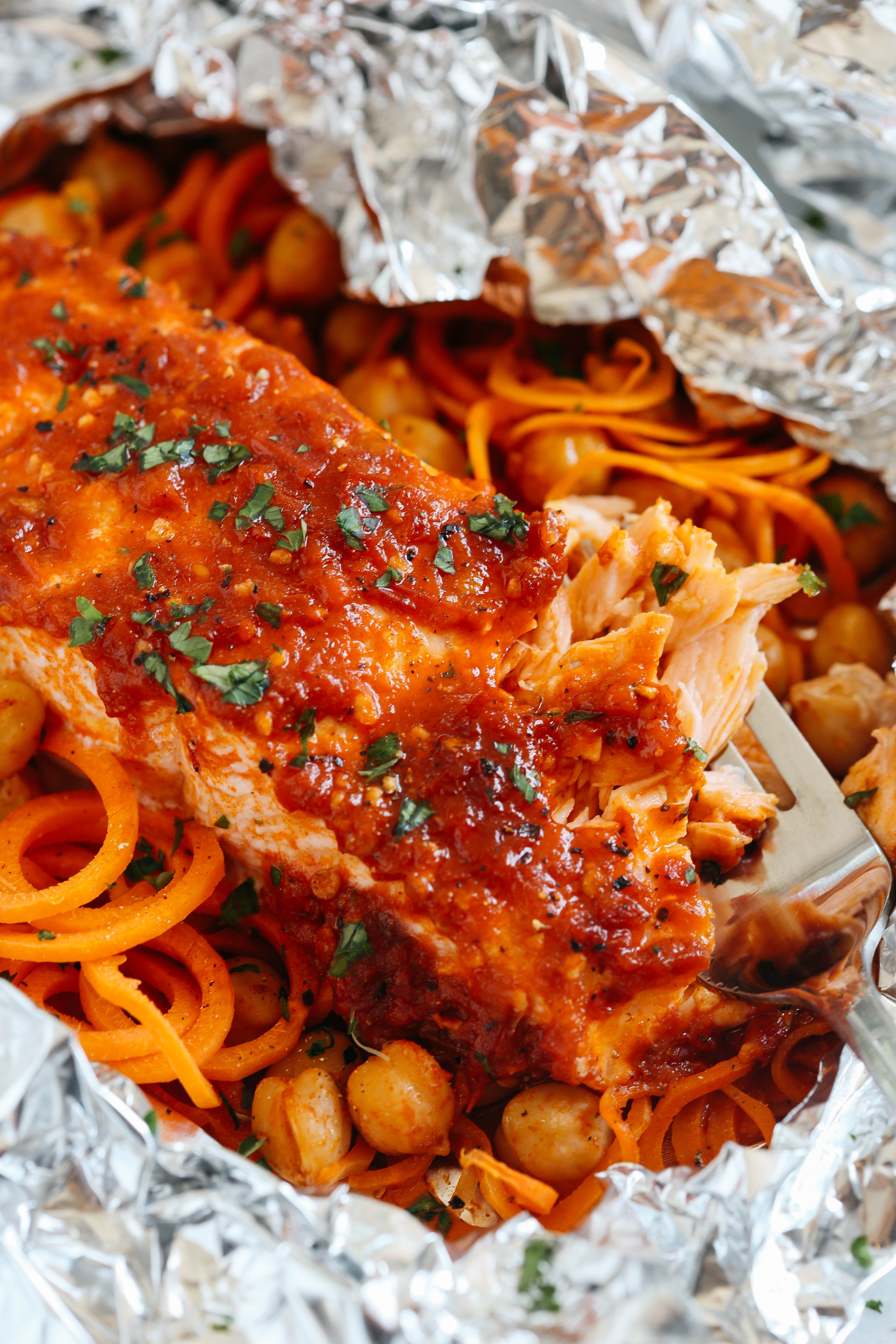 These Moroccan Salmon Foil Packets with Carrot Noodles & Chickpeas are sweet and spicy with tons of flavor and are easily made in just 20 minutes with little to no clean-up!