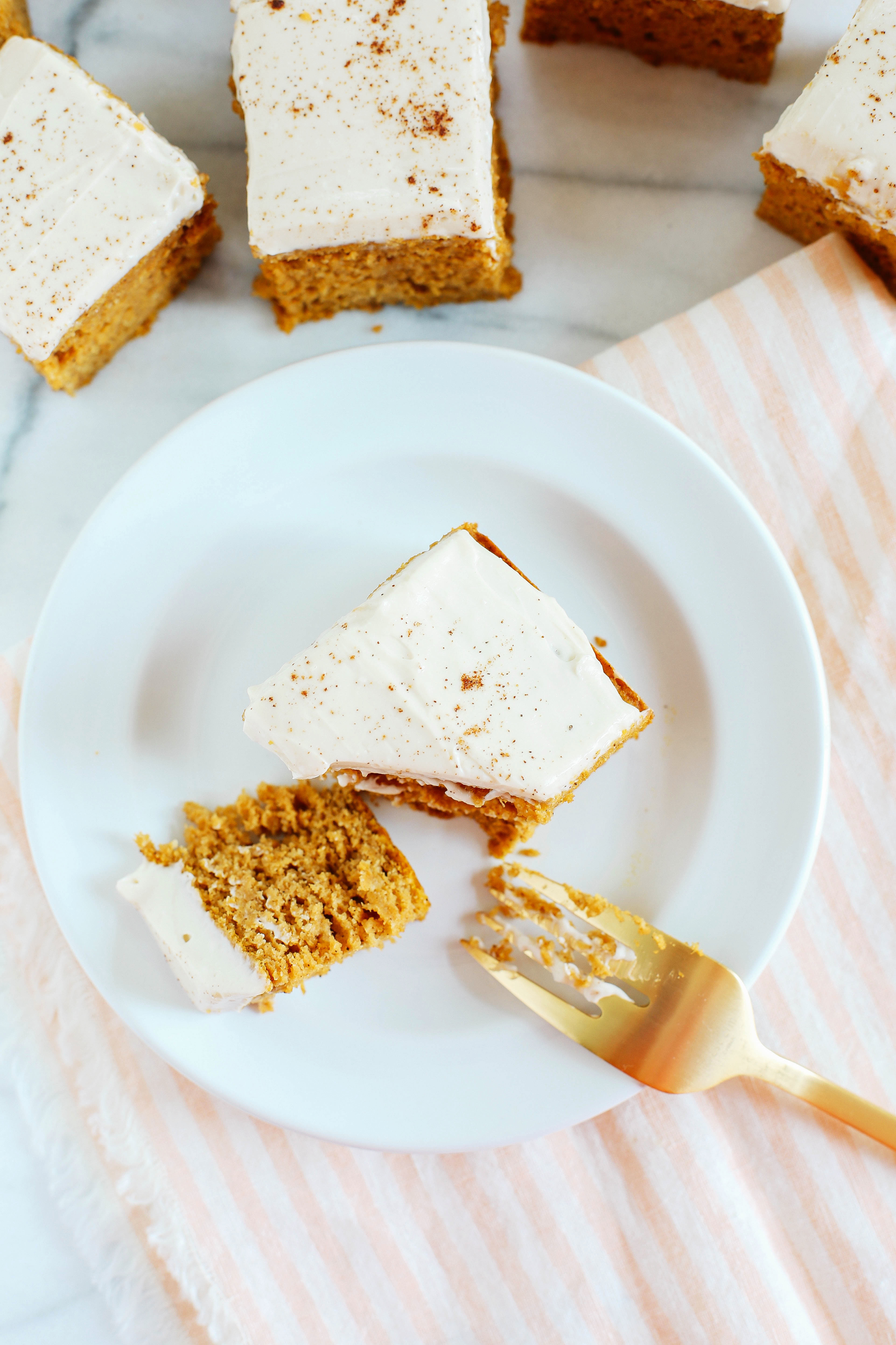 Kick off the fall season with these Healthier Pumpkin Bars with Cream Cheese Frosting that are moist, delicious and taste just like cake, but without any butter or refined sugar!