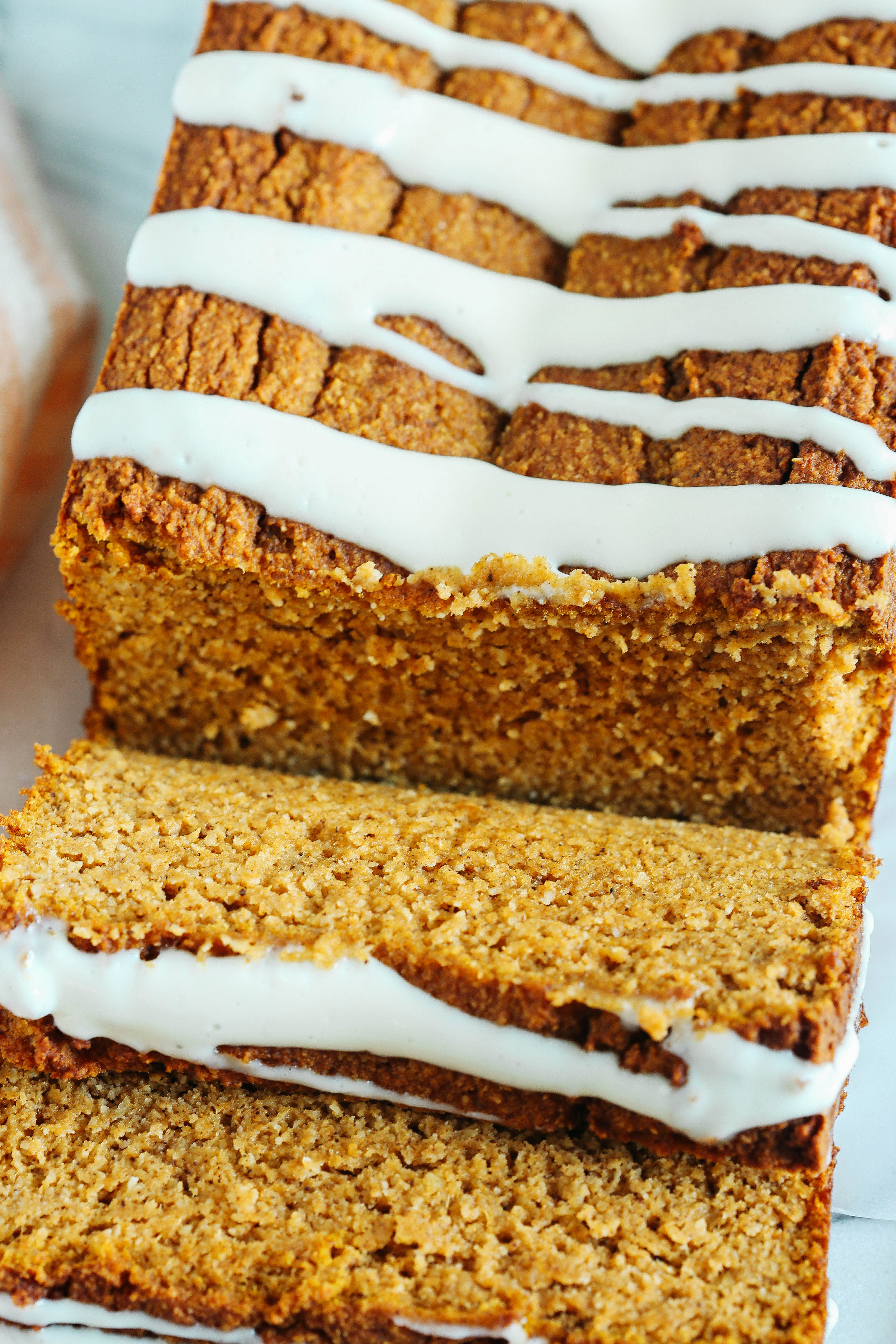 The BEST Almond Flour Pumpkin Bread recipe that is a must to make this fall!  Super moist, easy to make and drizzled with a delicious cream cheese glaze!