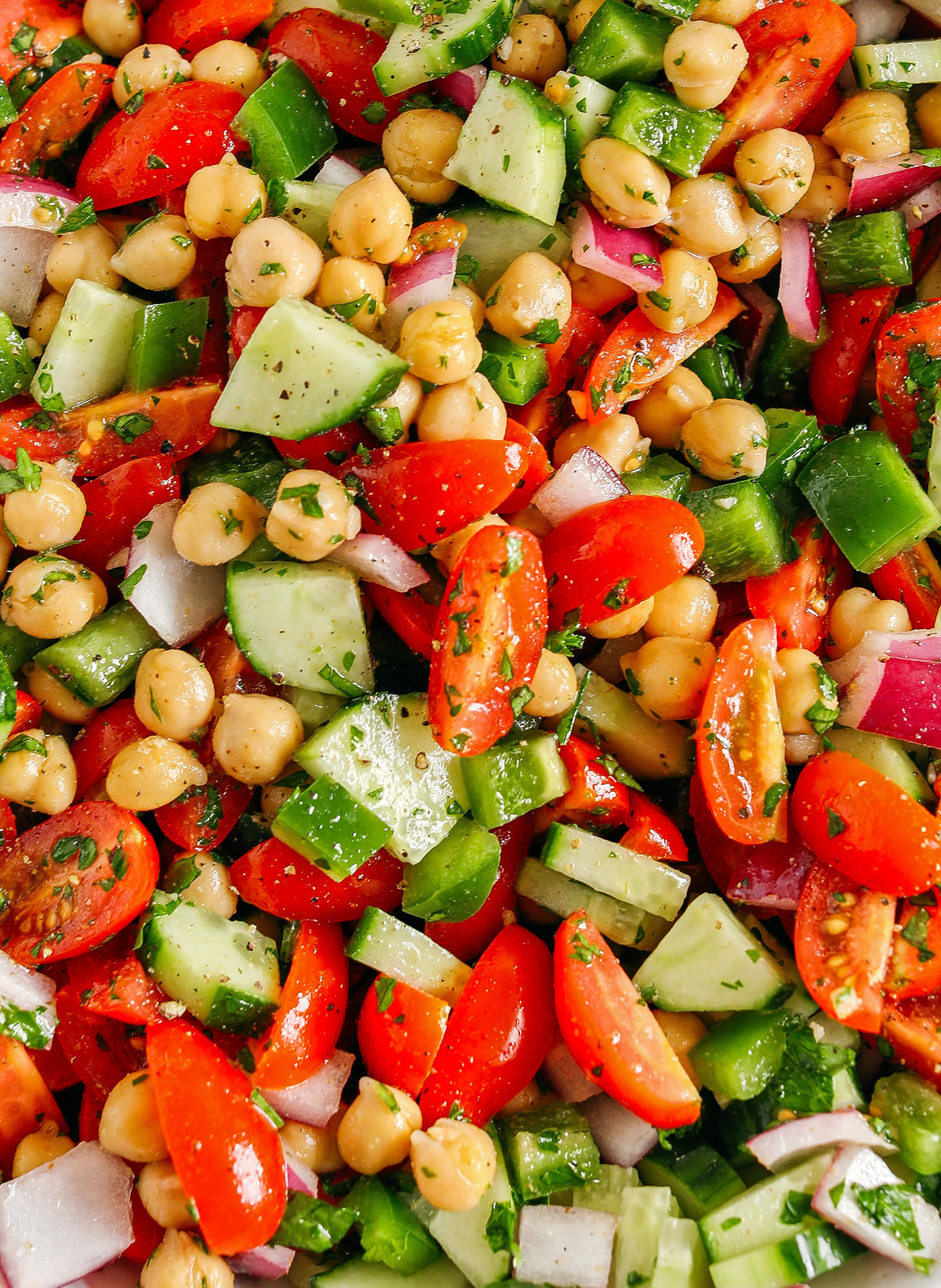 This Tomato, Cucumber and Chickpea Salad is a delicious summer staple made with fresh tomatoes, crisp cucumbers, chickpeas, red onion, and green bell pepper all tossed with a bright lemon vinaigrette!  Easy, healthy and the perfect side dish with grilled chicken, fish or steak!