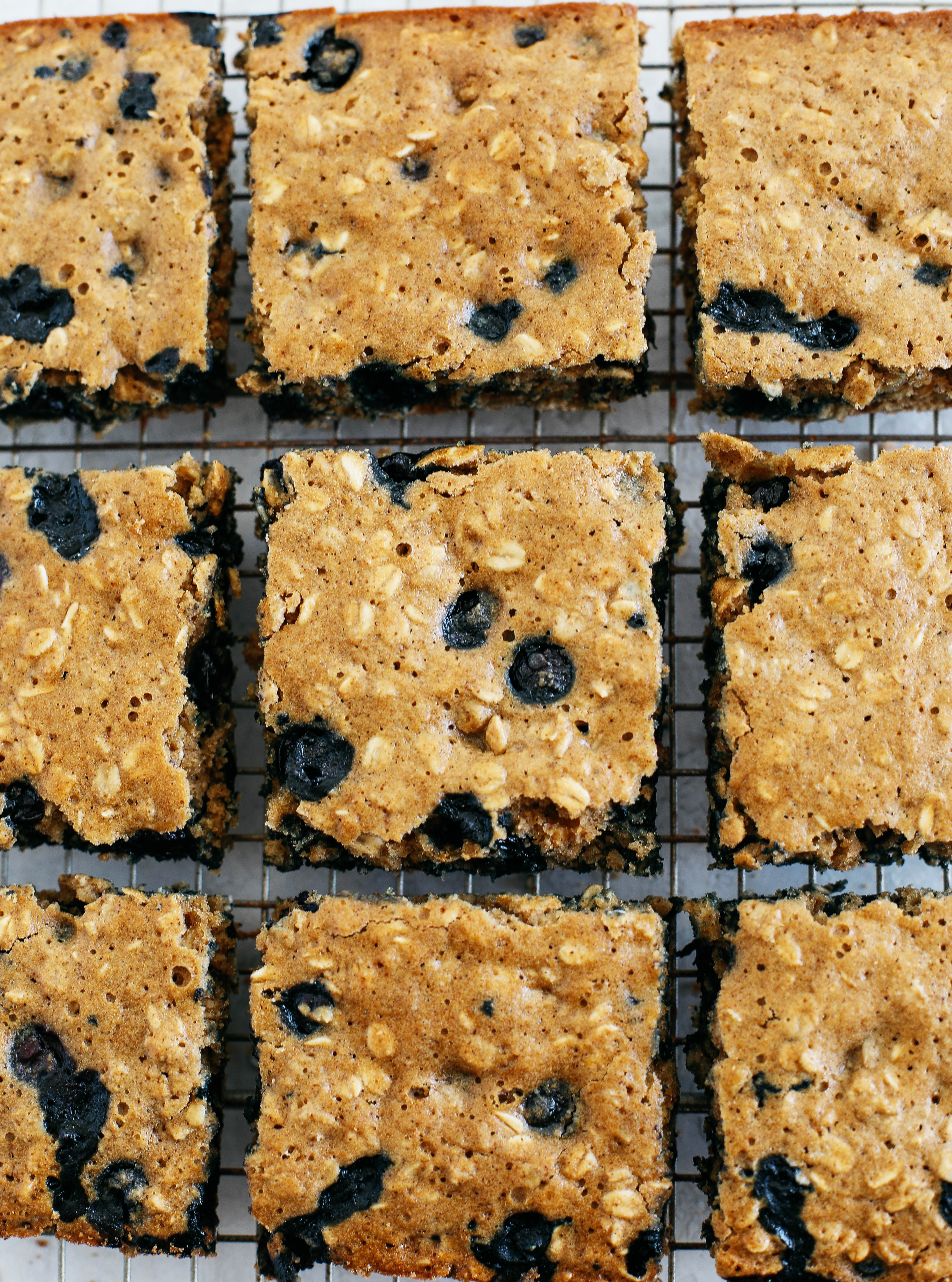 These delicious Blueberry Oatmeal Breakfast Bars make a quick on-the-go breakfast or snack option that are healthy, kid-friendly and super easy to throw together!