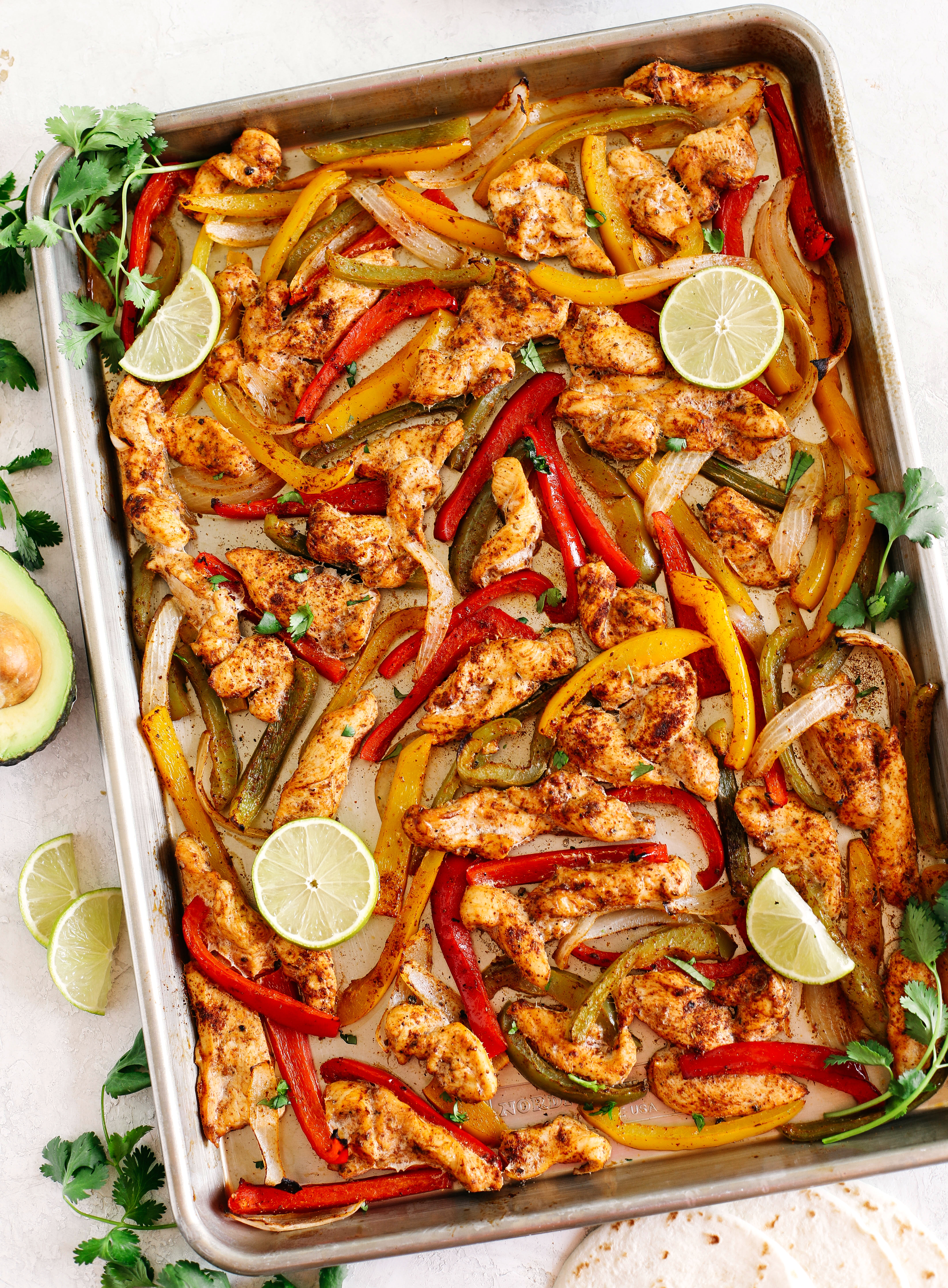 EASY Sheet Pan Chicken Fajitas with all your favorite Mexican flavors that makes the perfect healthy weeknight dinner easily made all on one pan in under 30 minutes!  Perfect recipe for your Sunday meal prep too!  