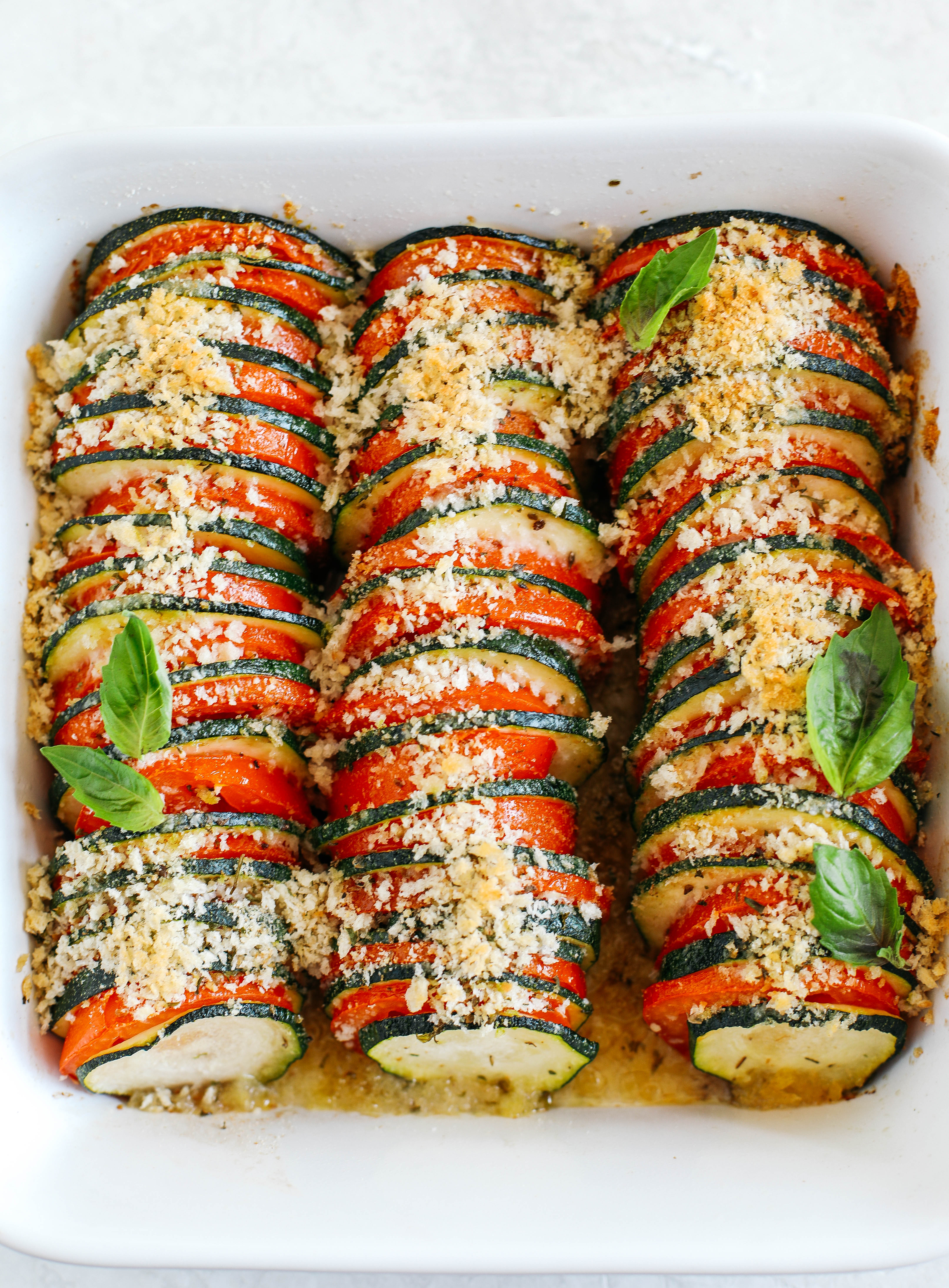 This Summer Zucchini and Tomato Gratin is filled with layers of delicious veggies all topped with a cheesy, crunchy herb topping that is baked to perfection!  