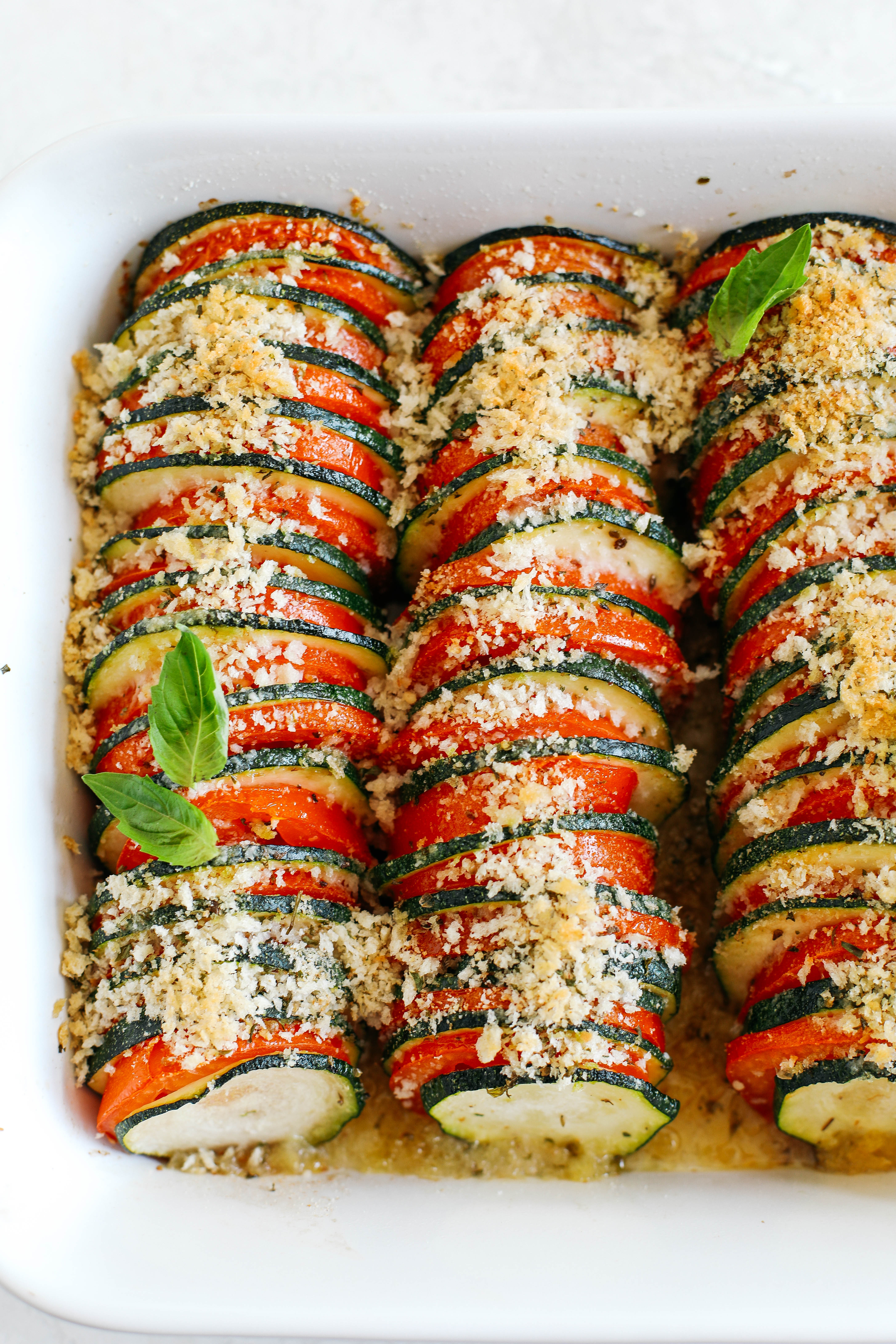 This Summer Zucchini and Tomato Gratin is filled with layers of delicious veggies all topped with a cheesy, crunchy herb topping that is baked to perfection!  