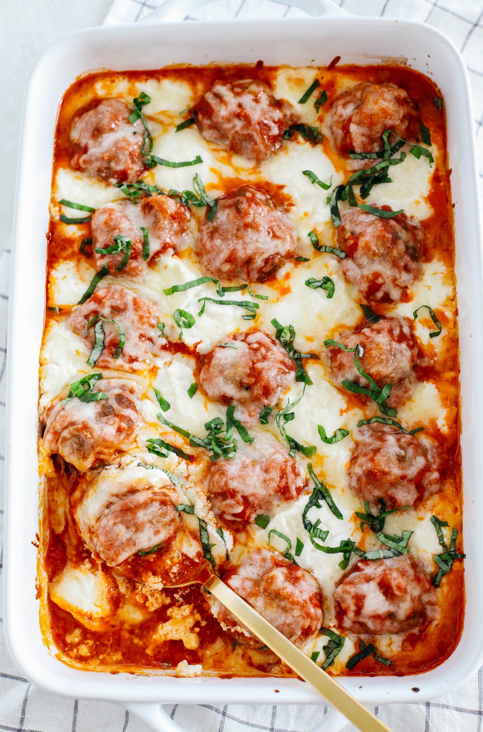 This Cheesy Keto Meatball Casserole is delicious and super filling with homemade meatballs topped with creamy ricotta cheese, mozzarella and parmesan for the perfect low carb meal your whole family will enjoy!