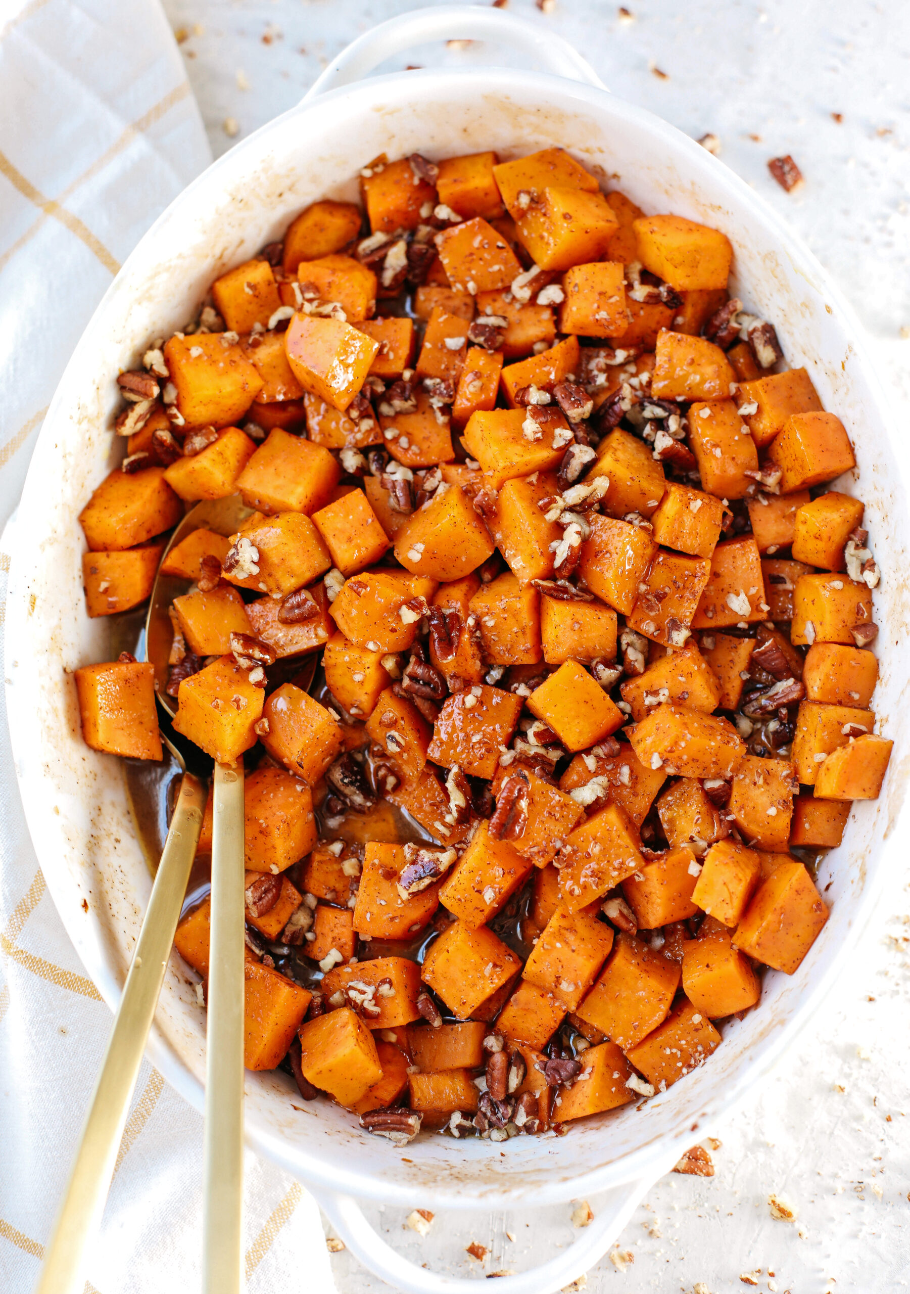 These Bourbon Maple Pecan Sweet Potatoes are one of my favorite holiday side dishes coated in the most delicious maple cinnamon glaze that will keep you coming back for seconds!