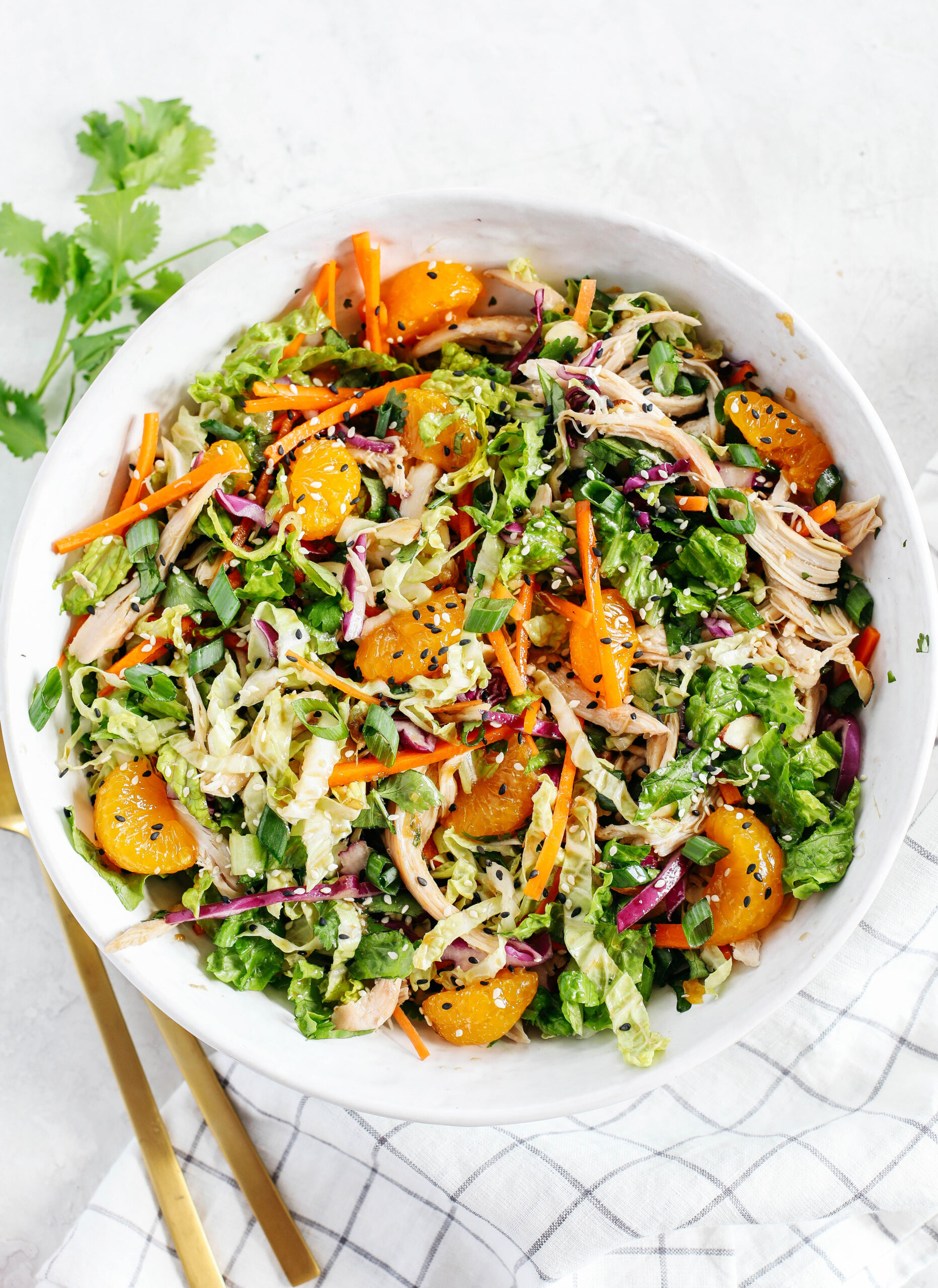 This Chinese Chicken Salad is loaded with fresh lettuce, cabbage, carrots, sweet mandarin oranges, crunchy almonds and cilantro all tossed together with a delicious ginger-sesame vinaigrette!