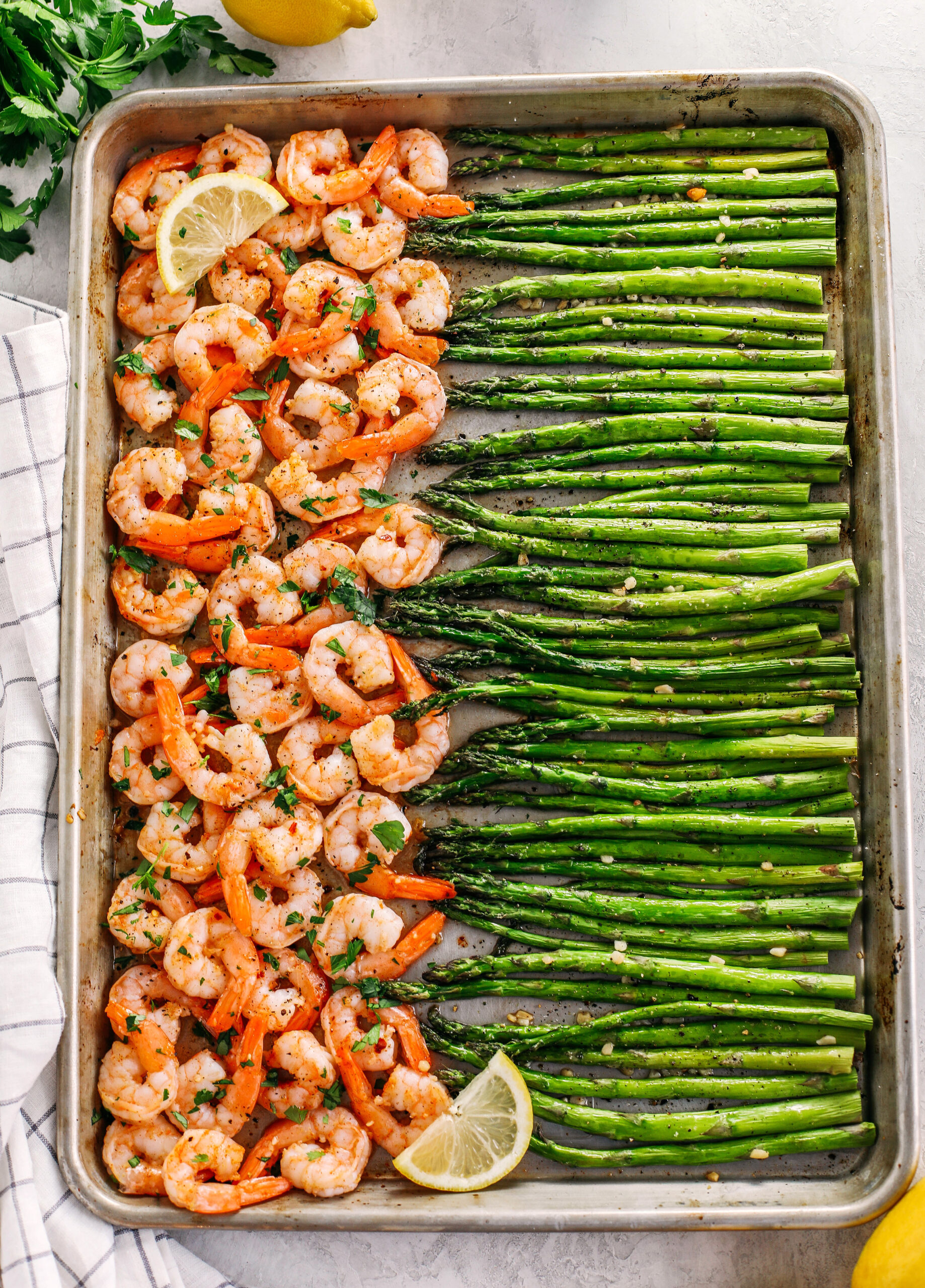 This Sheet Pan Lemon Garlic Shrimp and Asparagus is the perfect weeknight dinner loaded with flavor and easily made all in one pan in under 20 minutes!