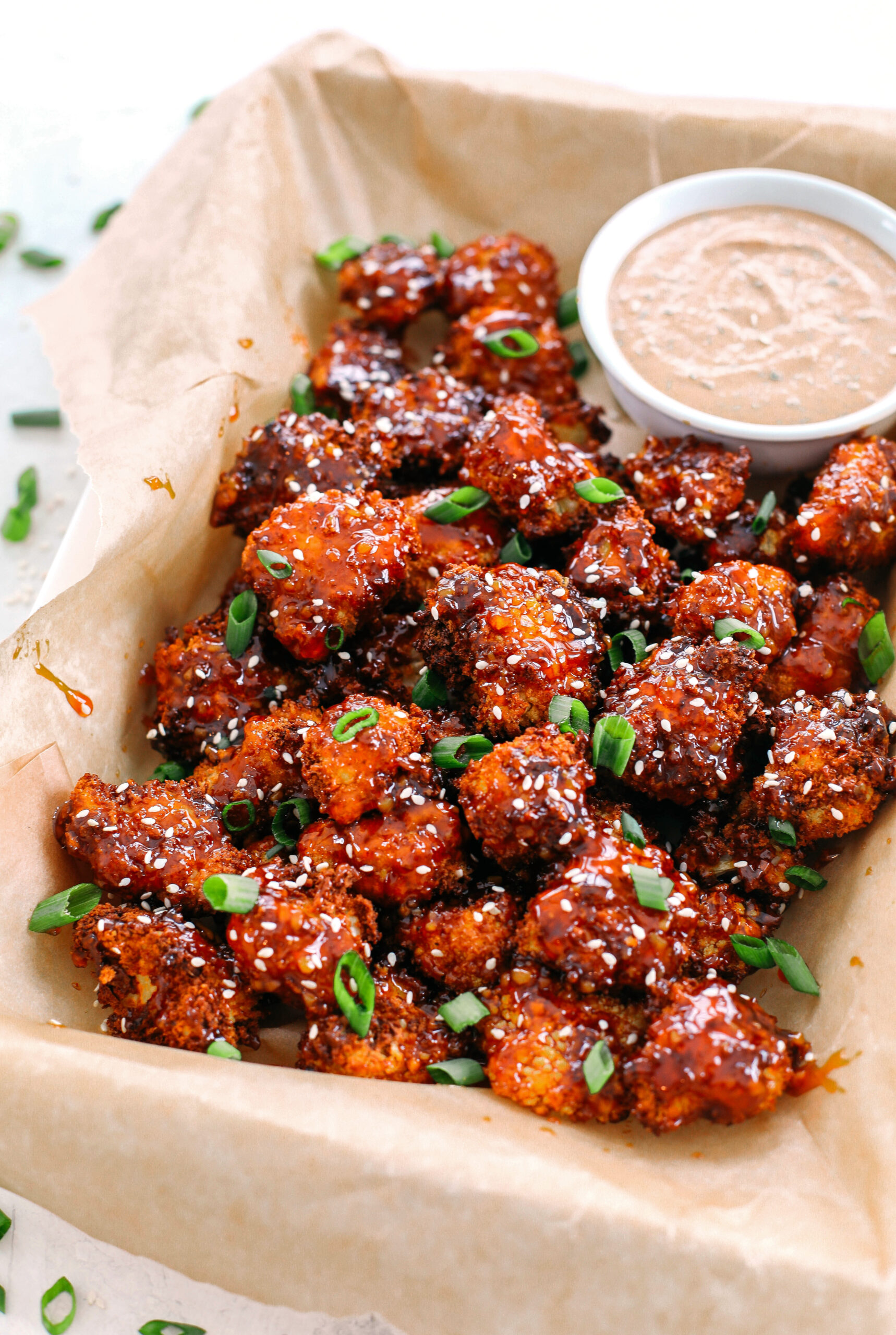 These Sticky Honey Garlic Cauliflower Wings are sweet, spicy and perfect for game day!  Easily made in the air fryer and served with the most delicious spicy ranch dipping sauce!