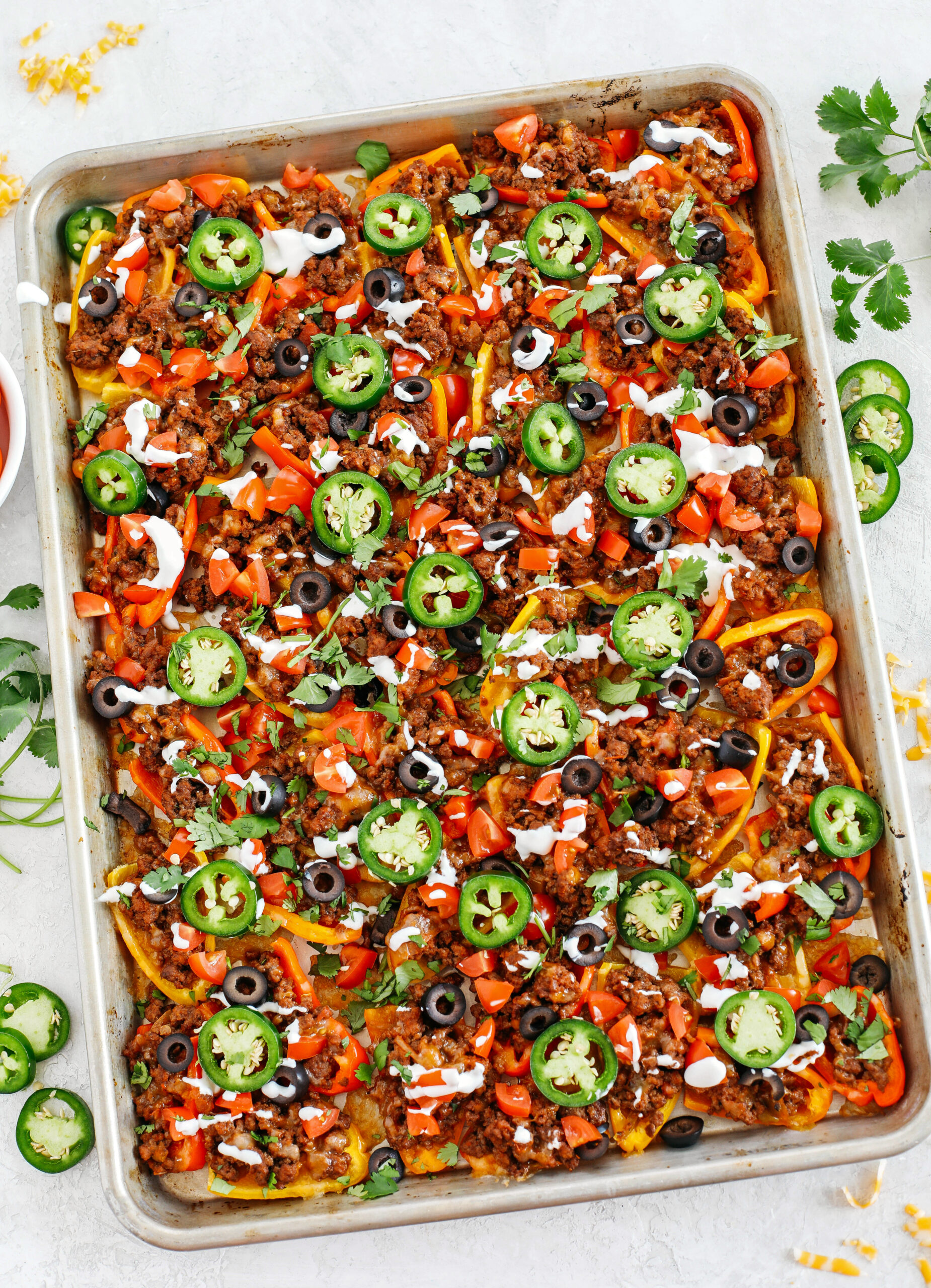 These Sheet Pan Loaded Bell Pepper Nachos are packed with all your favorite flavors and fun toppings making them the perfect low carb appetizer to enjoy on game day!  