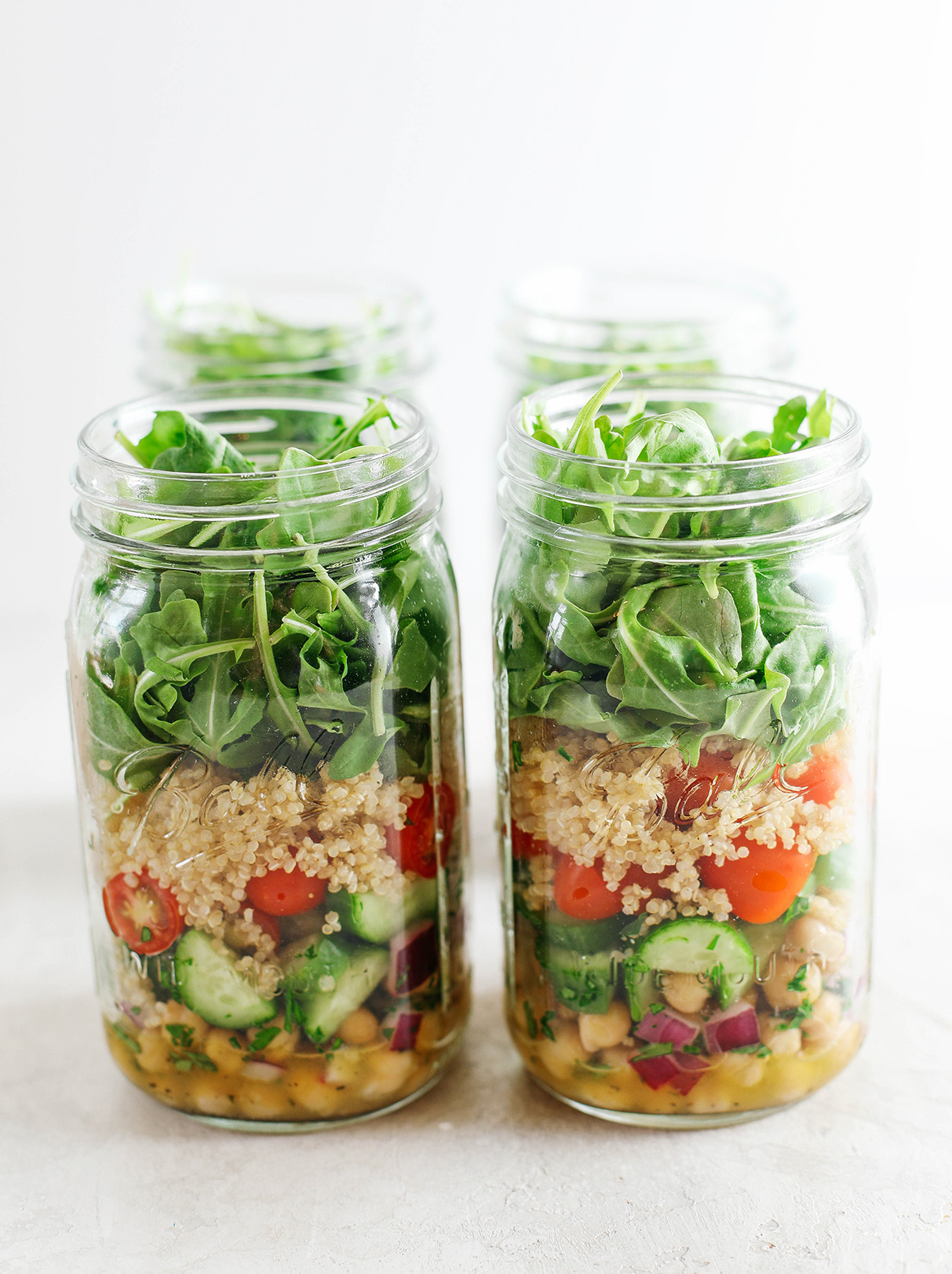 These protein-packed Mediterranean Mason Jar Salads are layered with fresh veggies, quinoa, and chickpeas with the most delicious lemon garlic dressing!  Perfect for meal prep and super easy to assemble! 