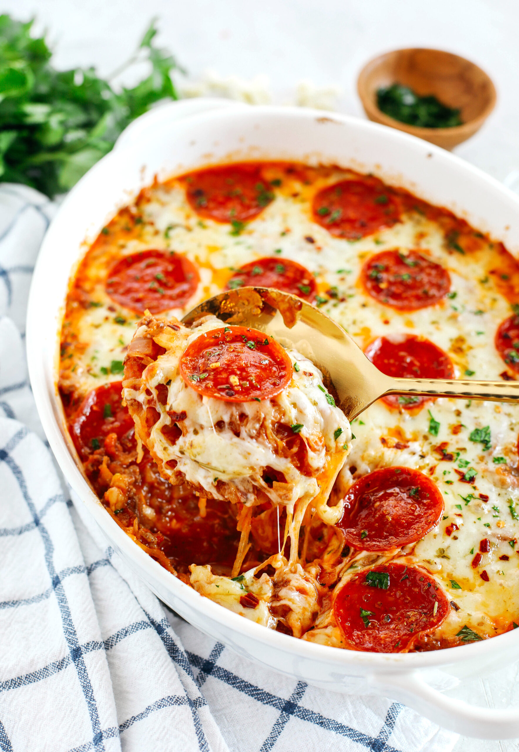 This Spaghetti Squash Pizza Casserole is the perfect low carb comfort food that is delicious, super filling and made with seasoned ground beef, melty cheese and your favorite marinara!