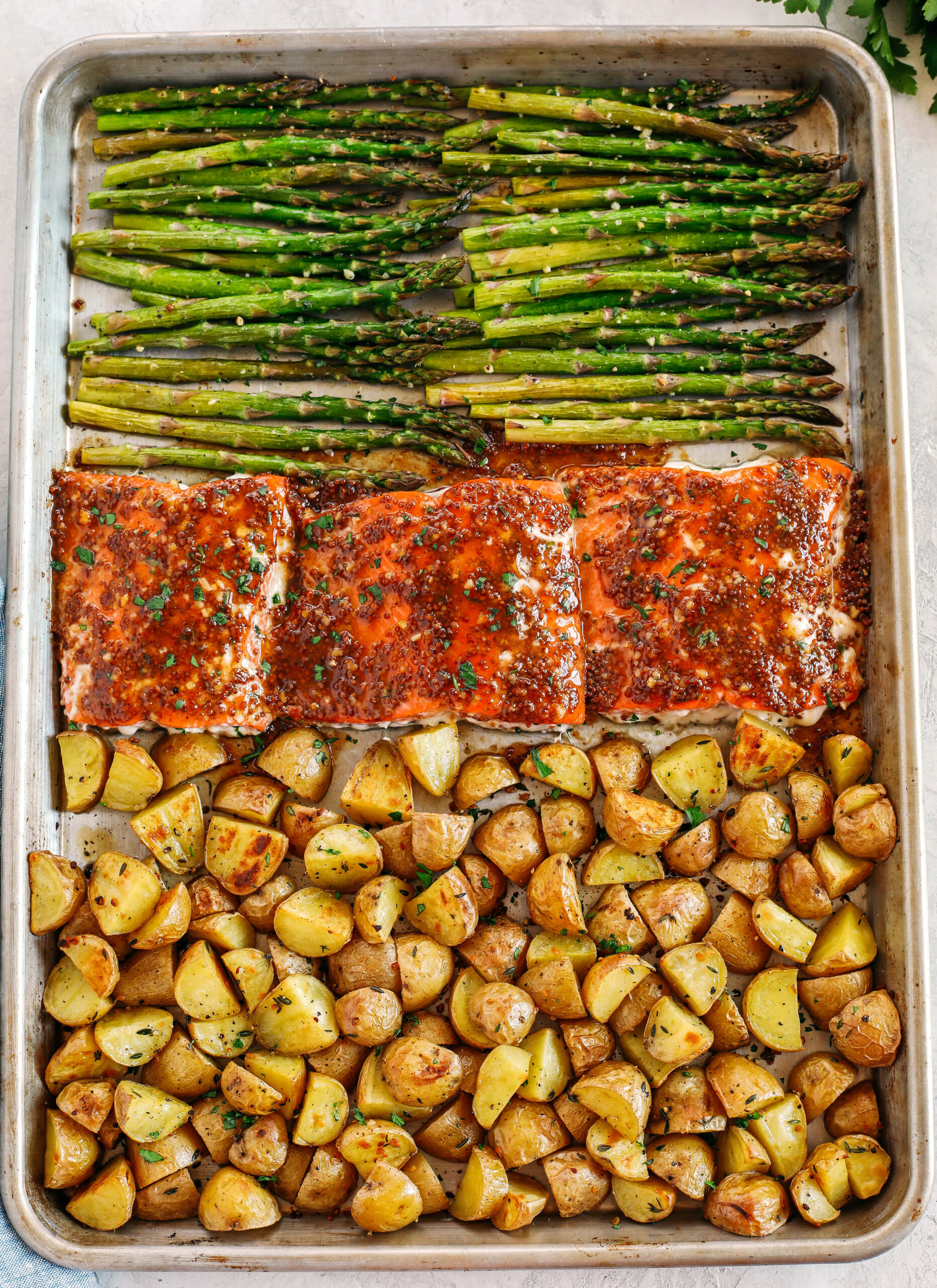 Sheet Pan Maple Dijon Glazed Salmon with roasted asparagus and tender seasoned potatoes make the perfect weeknight dinner that is easily made all in one pan in just 30 minutes!