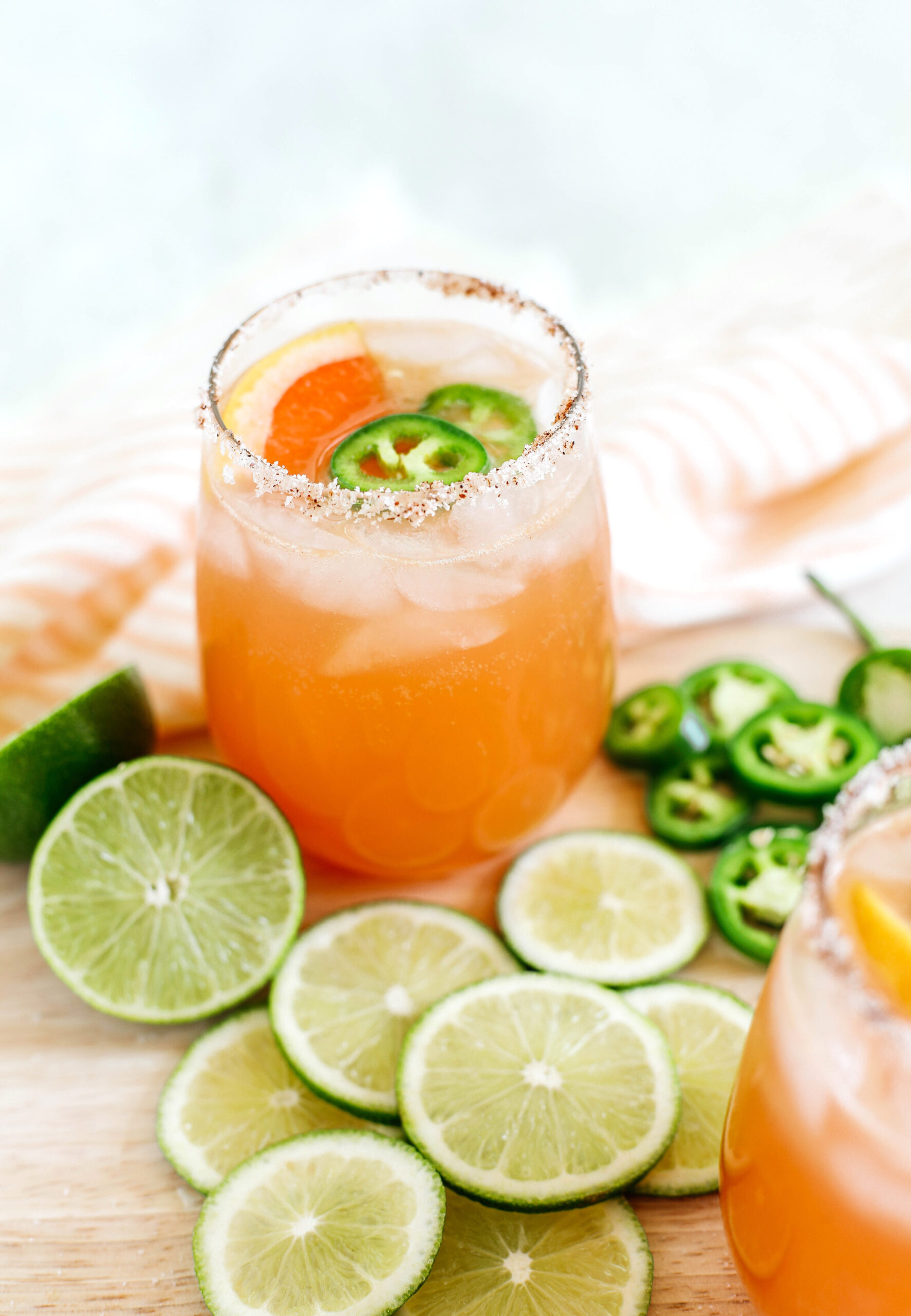 This Spicy Grapefruit Paloma is the perfect summer cocktail made with fresh limes and grapefruit, your favorite tequila, sparkling water, and my sweet and spicy jalapeño honey simple syrup!