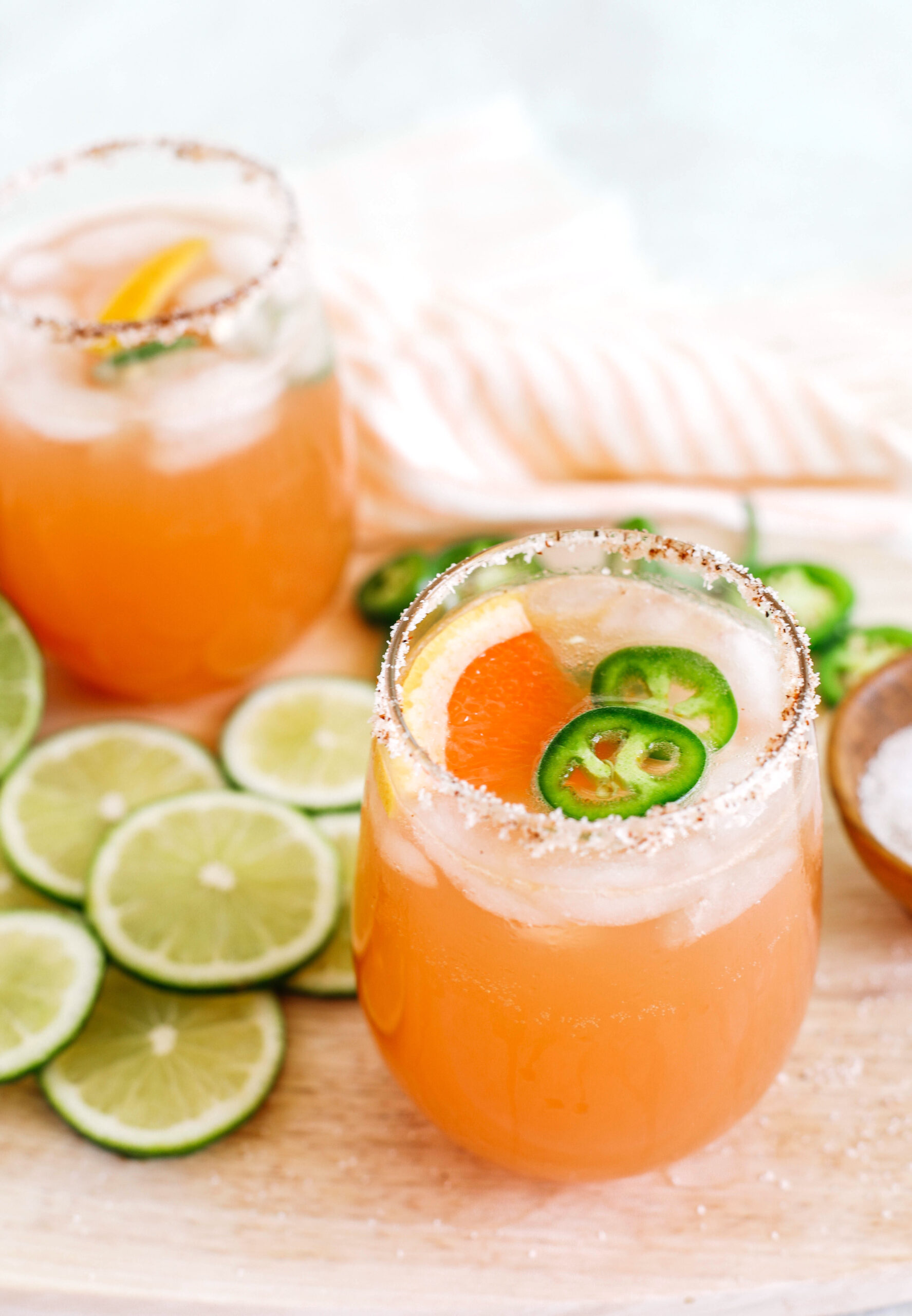 This Spicy Grapefruit Paloma is the perfect summer cocktail made with fresh limes and grapefruit, your favorite tequila, sparkling water, and my sweet and spicy jalapeño honey simple syrup!