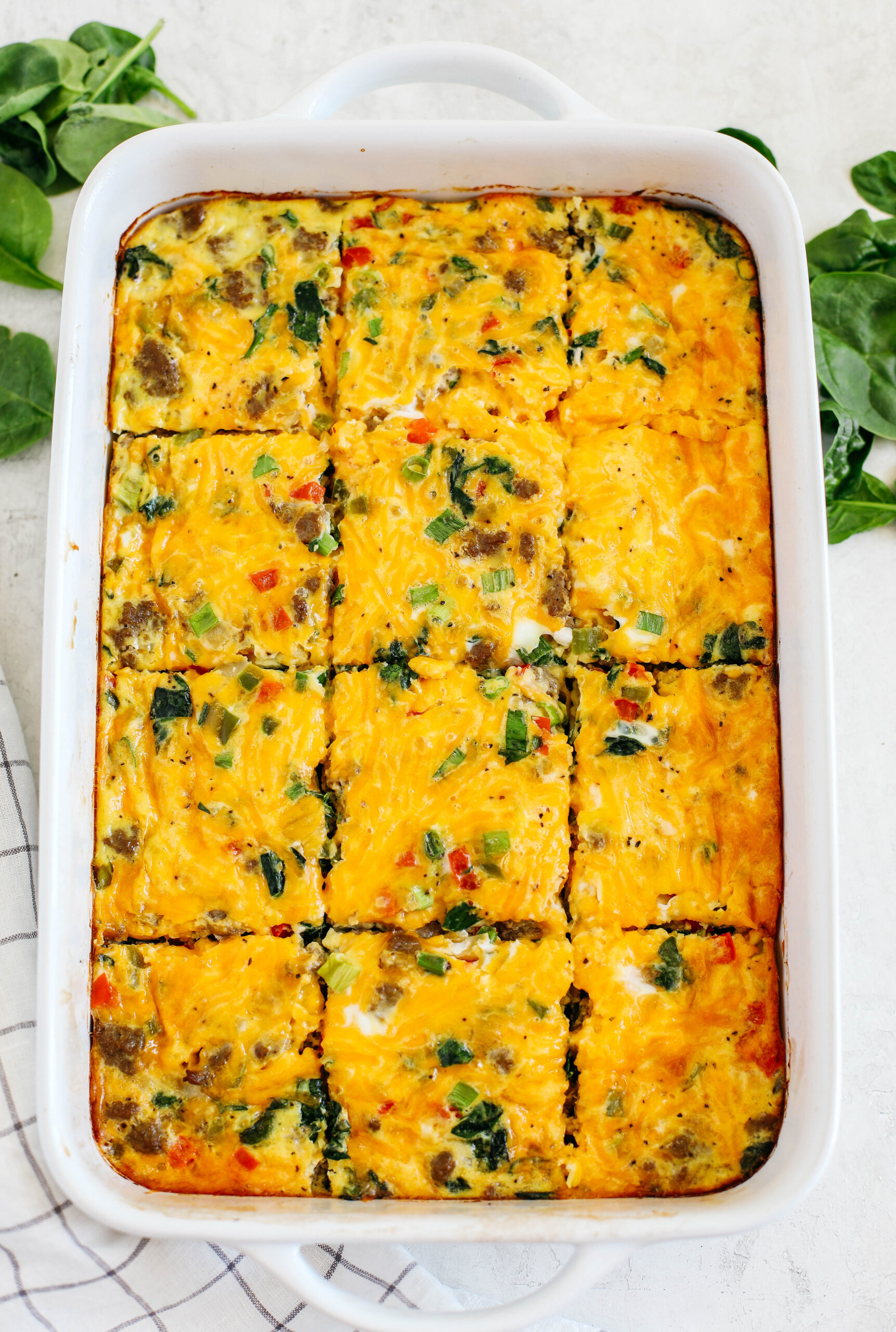 This Sausage and Veggie Egg Casserole makes the perfect low carb savory breakfast loaded with your favorite veggies, leafy greens, and delicious turkey sausage that is sure to be a crowdpleaser!