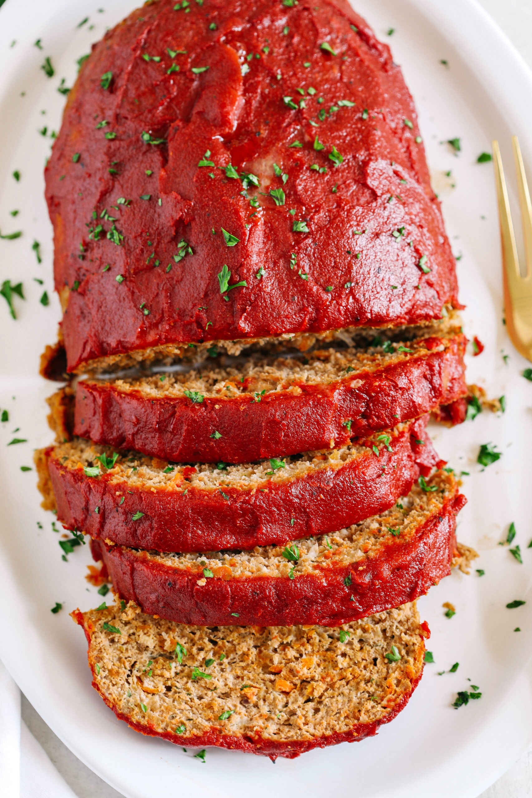 The BEST Healthy Turkey Meatloaf that is moist, super flavorful, and packed with hidden veggies all topped with a delicious tomato glaze!