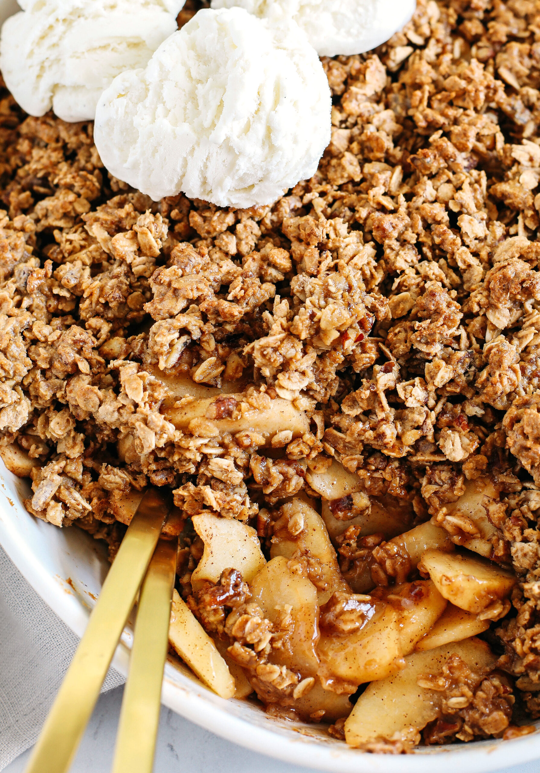 This Healthy Apple Crisp is loaded with tender apples and warm spices, naturally sweetened with maple syrup, all topped with a crunchy oatmeal pecan topping! 