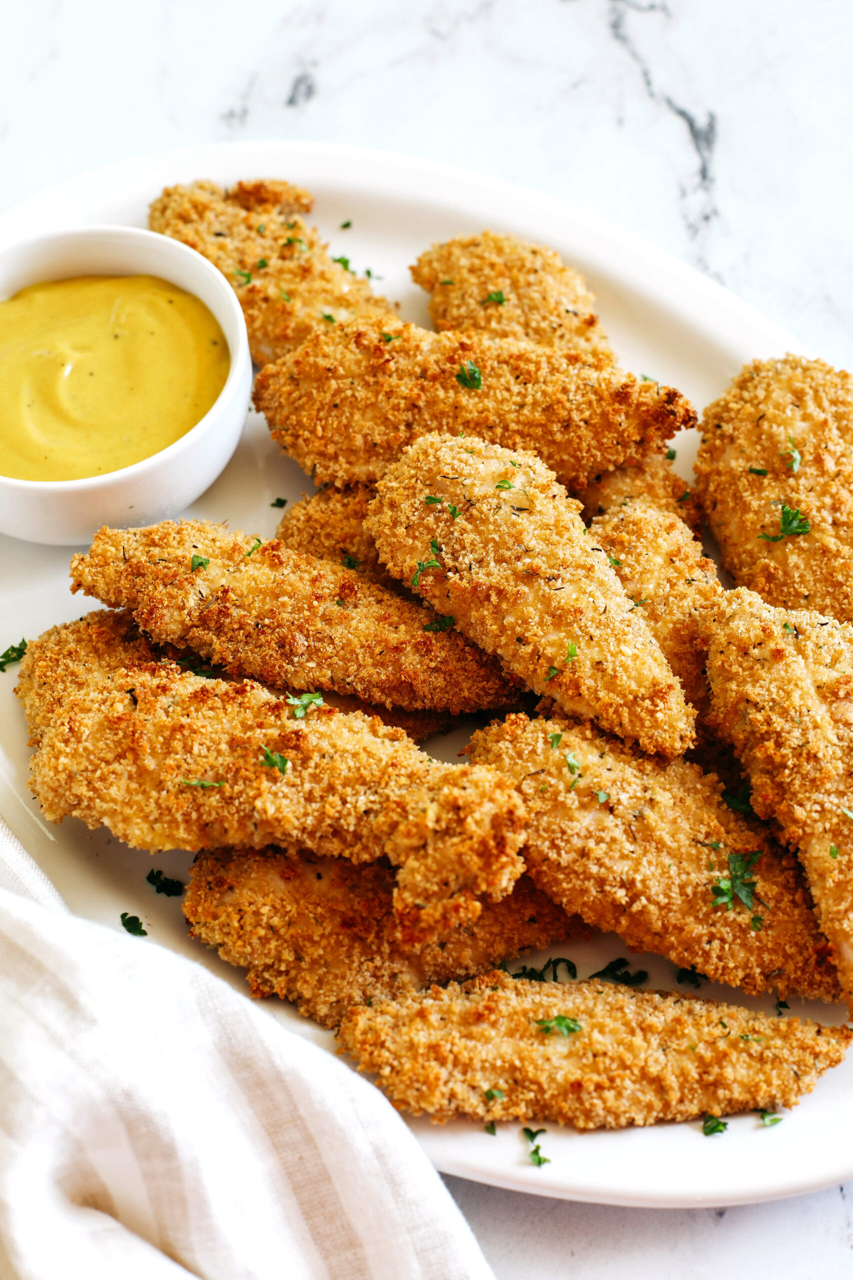 Easy Baked Chicken Tenders that are perfectly crispy, full of flavor and easily made in just 20 minutes!  So delicious served with your favorite dipping sauce!