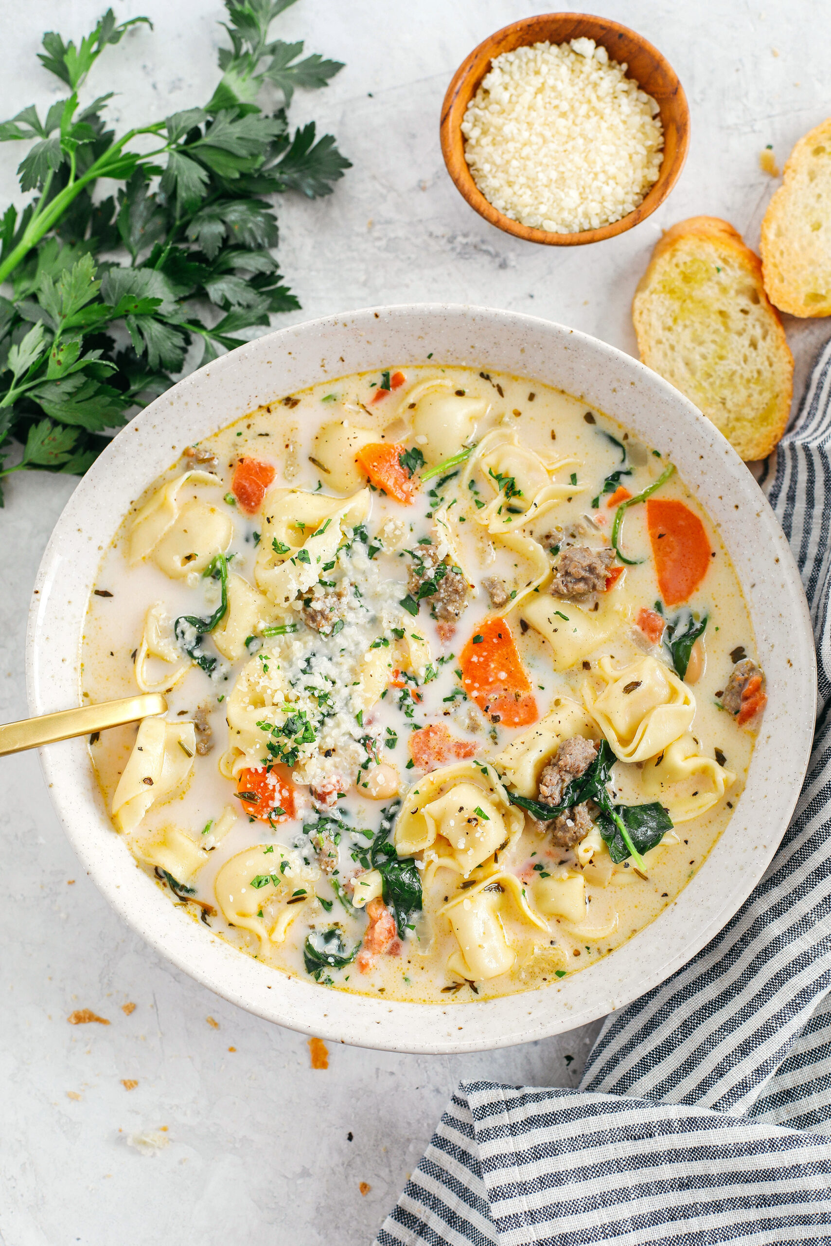 This Creamy Sausage & Spinach Tortellini Soup is delicious, loaded with veggies and makes the perfect cozy meal that can easily be made in your instant pot, slow cooker or right on the stove!