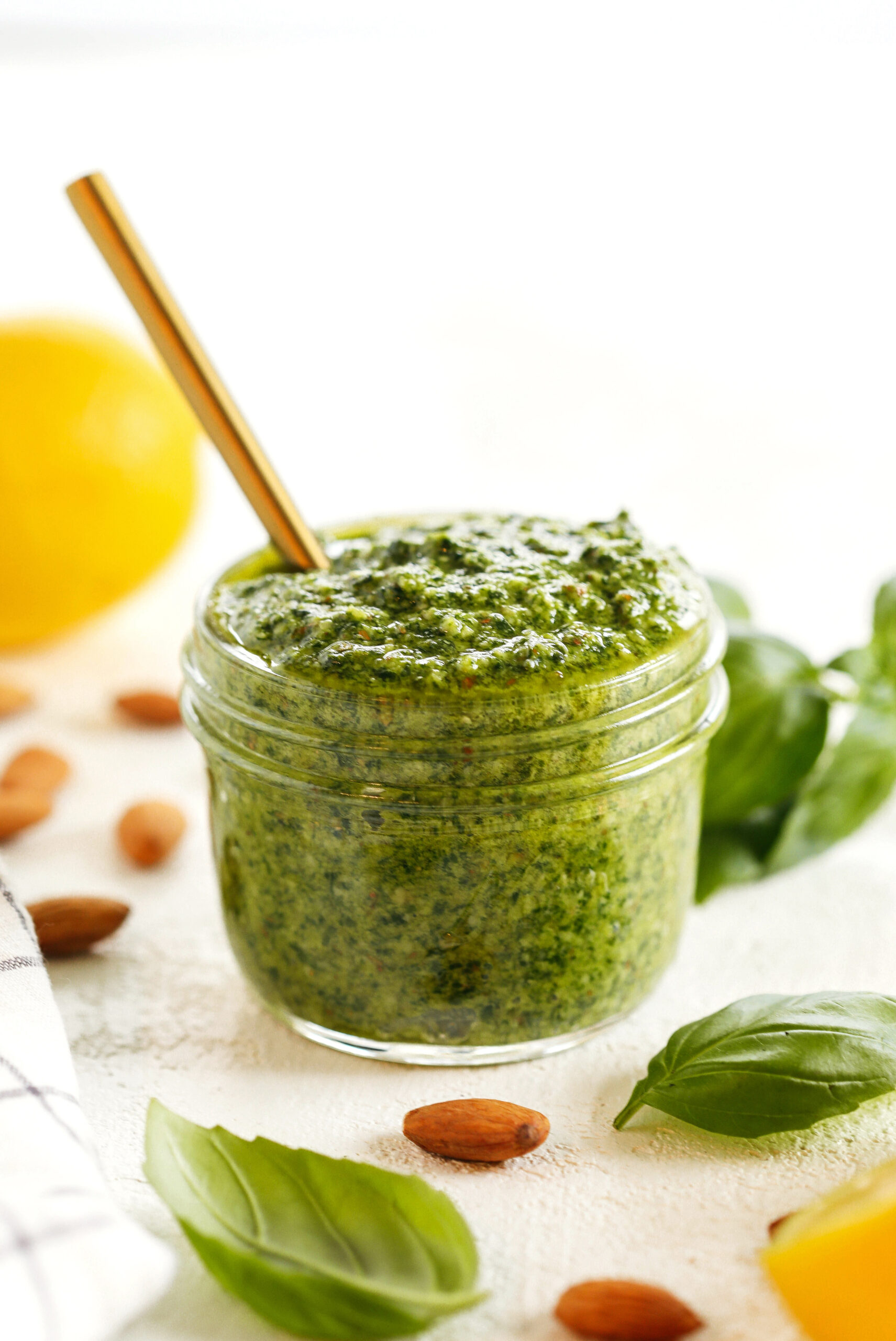 This Simple Basil Almond Pesto recipe combines fresh, delicious ingredients that is easily made in just 10 minutes!  So versatile and perfect with pizza, pasta, chicken, shrimp or veggies!