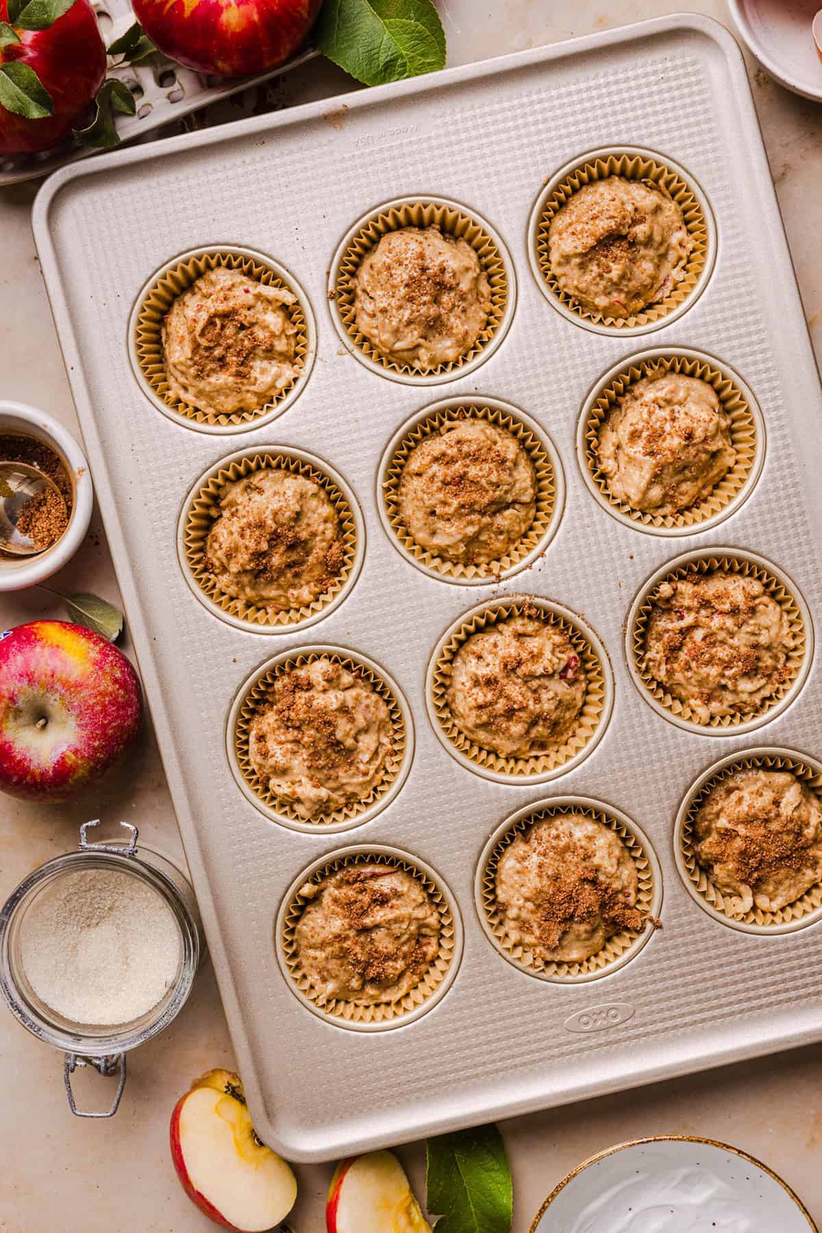 Healthy apple cinnamon muffin batter in a muffin tin
