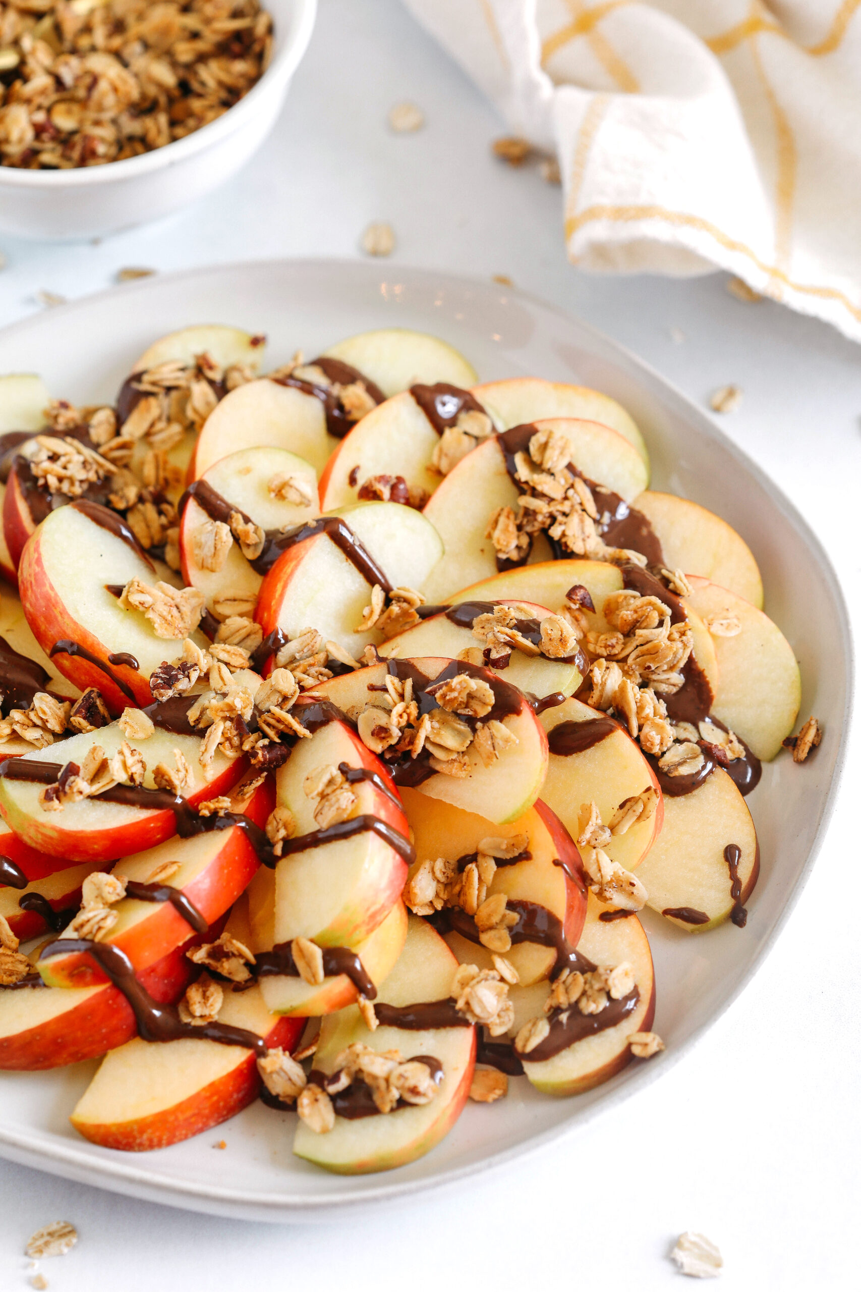 Delicious Chocolate Granola Apple Wedges easily made in just 10 minutes for the perfect after-school fall snack!  Sliced apples layered with melted chocolate and sprinkled with homemade granola!