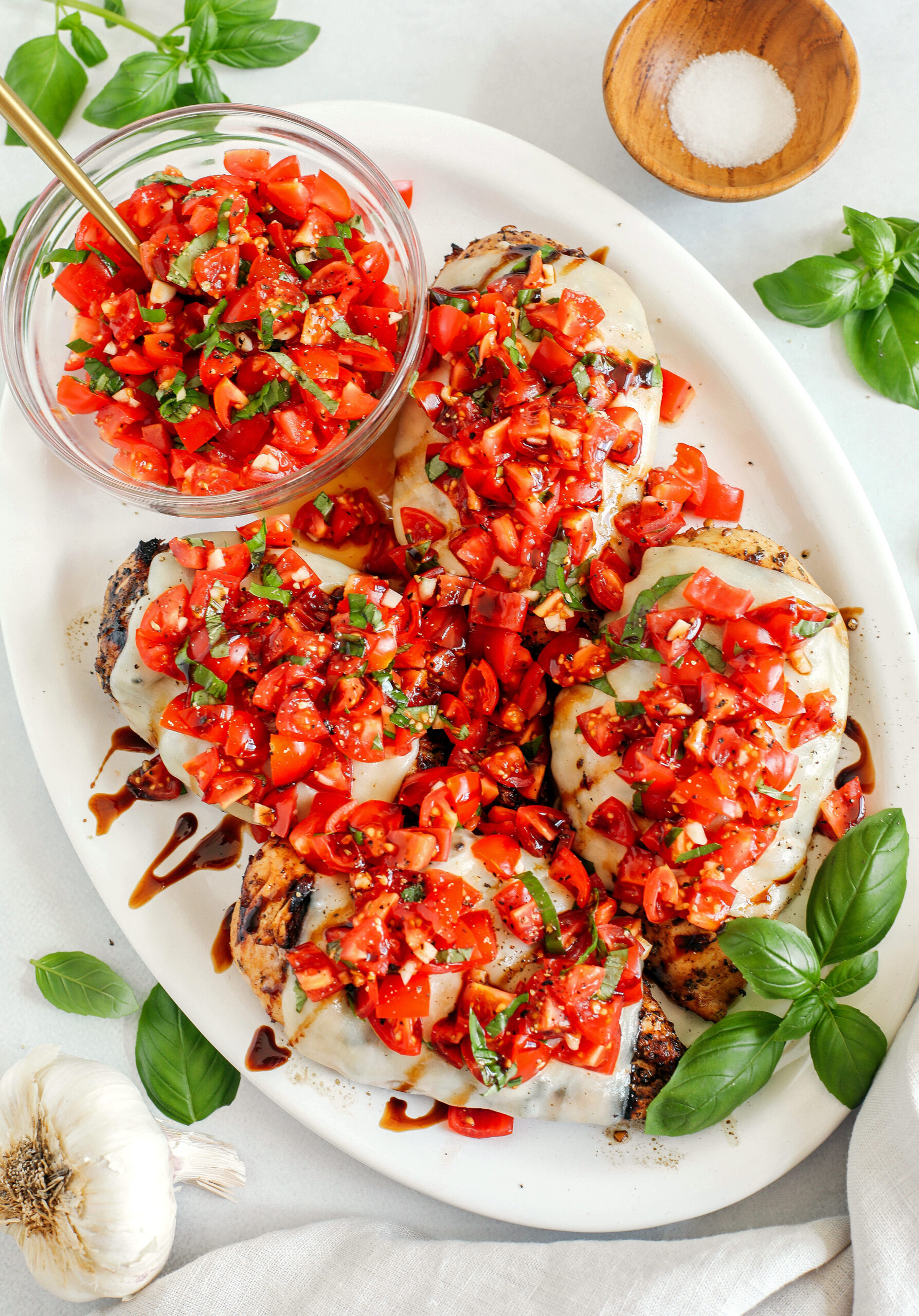 This Grilled Bruschetta Chicken is super easy to make and marinated in the most delicious lemon balsamic dressing all topped with melty mozzarella cheese and fresh tomato bruschetta for the perfect summer meal!