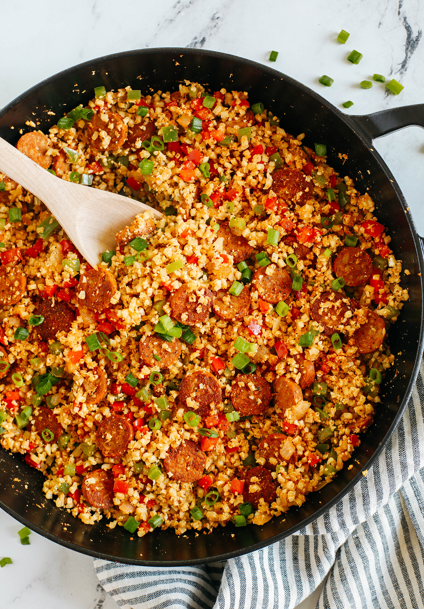 This Cajun Sausage and Cauliflower Rice Skillet is loaded with peppers, onions, andouille chicken sausage and tender riced cauliflower seasoned to perfection with our homemade Cajun seasoning!  The perfect low carb dinner for your family!