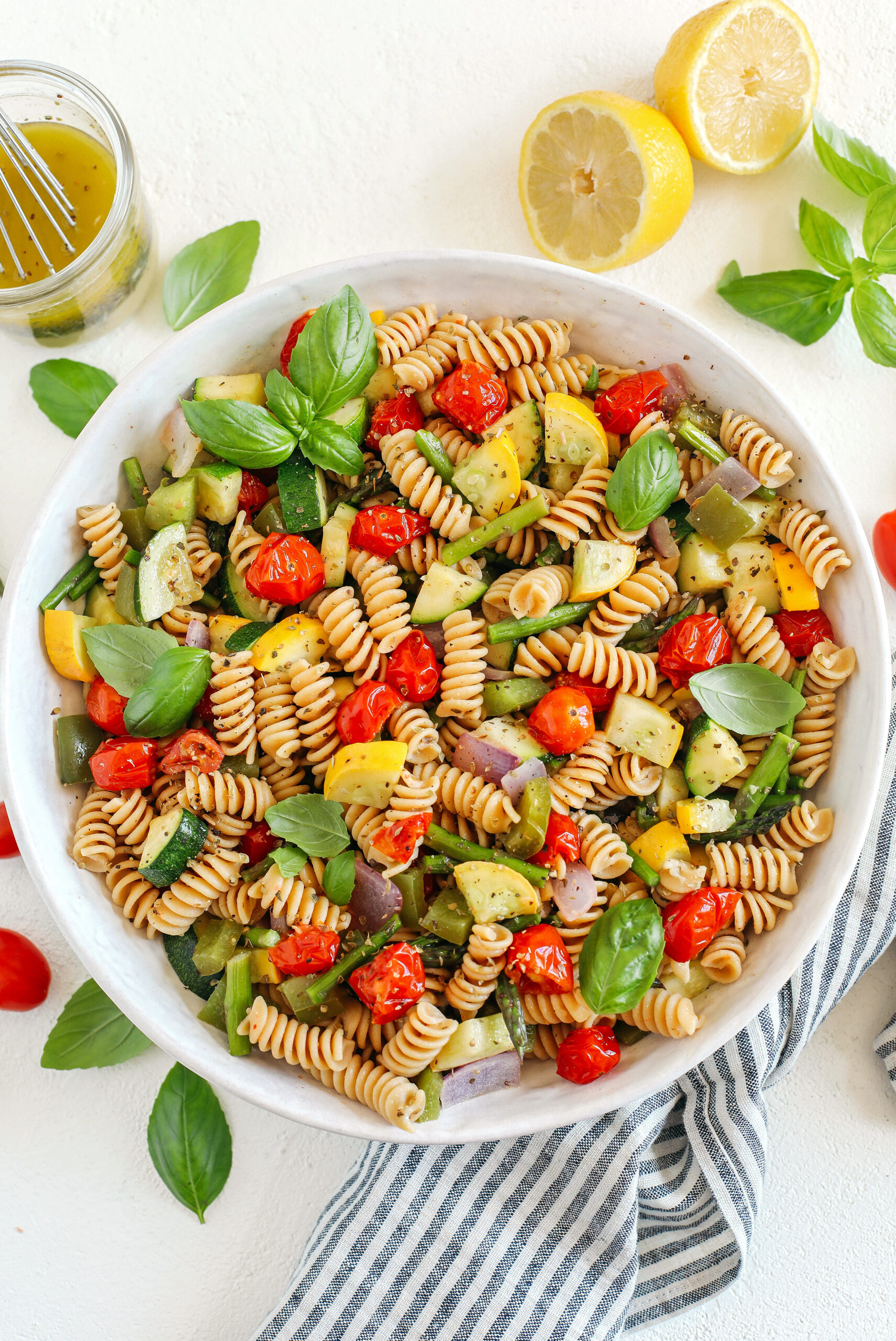 This EASY Roasted Veggie Pasta Salad is loaded with fresh ingredients like juicy tomatoes, zucchini, squash, asparagus, and bell pepper, all tossed together with a delicious lemon herb dressing!