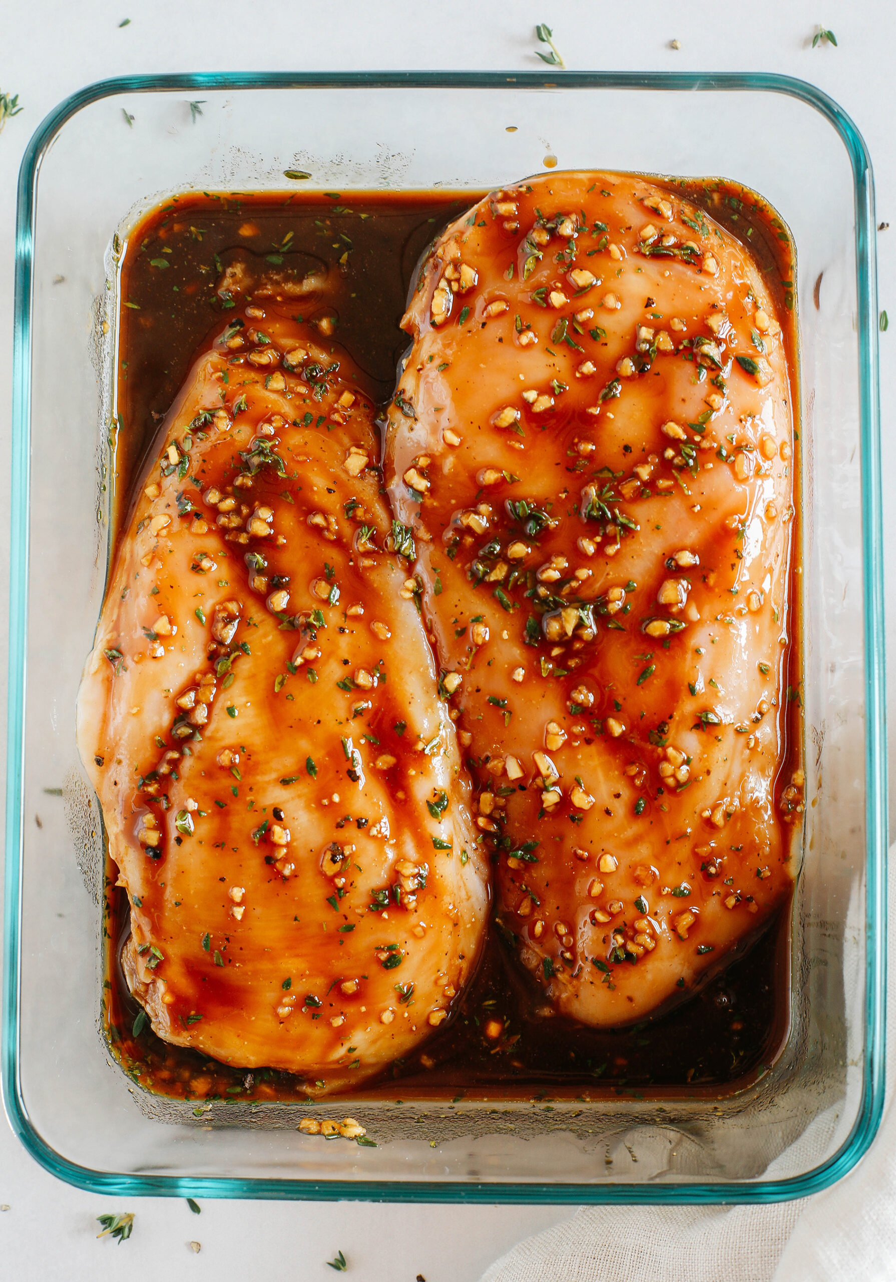Moist and juicy chicken breasts marinated in a rich maple balsamic herb glaze, seasoned with fresh herbs, and grilled to perfection for a healthy weeknight meal! 