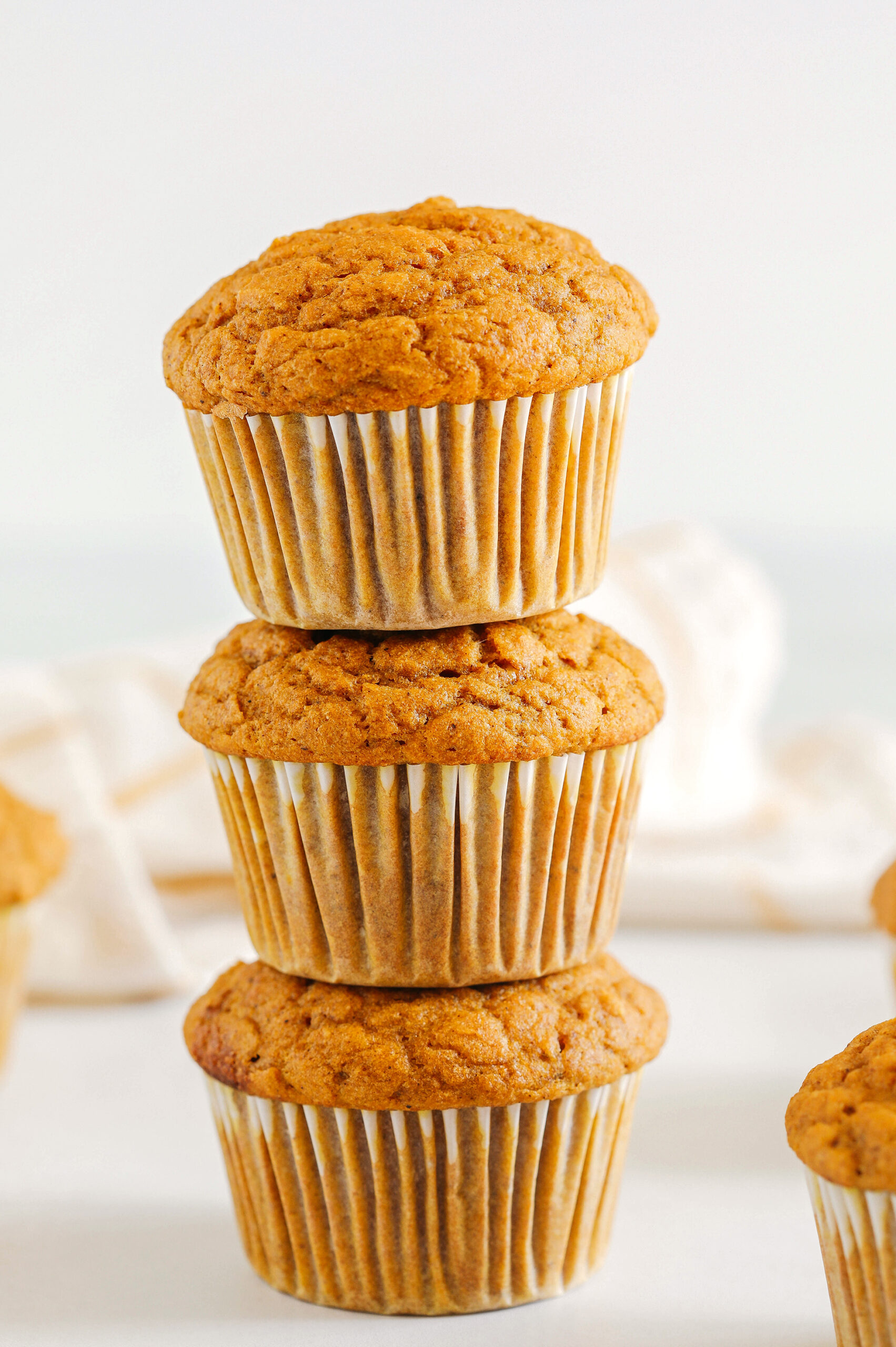 These Whole Wheat Pumpkin Muffins are moist, fluffy, and made healthier with whole wheat flour, Greek yogurt, and zero butter or refined sugar.  Loaded with delicious pumpkin flavor and warm spices for the perfect fall muffin!